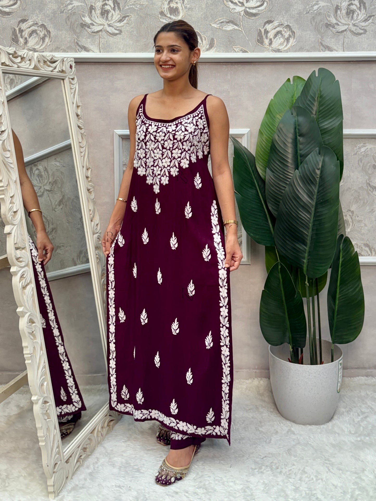 Wine sleeveless Lucknow Chikankari rayon kurta and pant set with white hand embroidery.