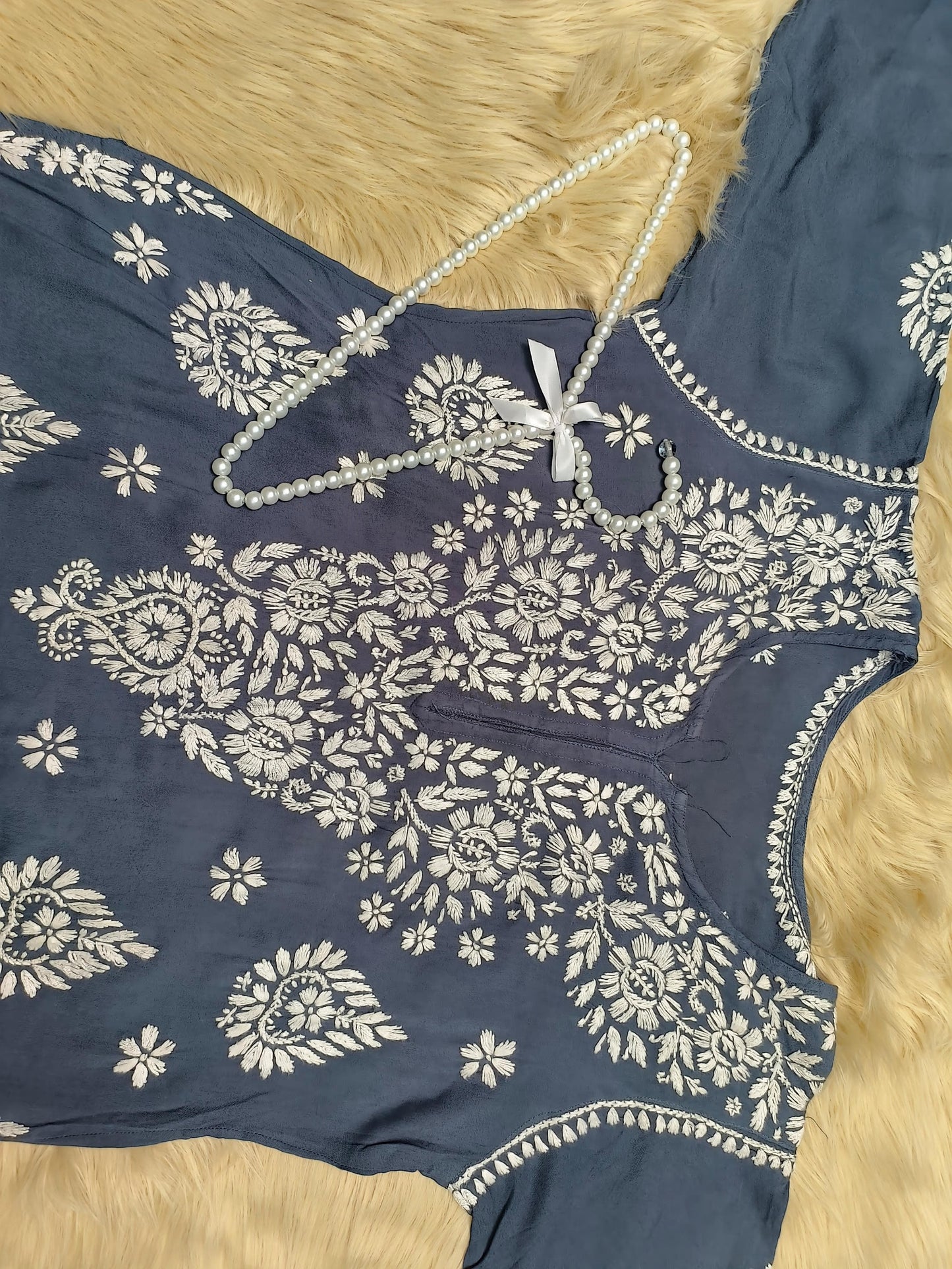 Indigo blue rayon chikankari kurta and pant set with white floral embroidery displayed on fur background