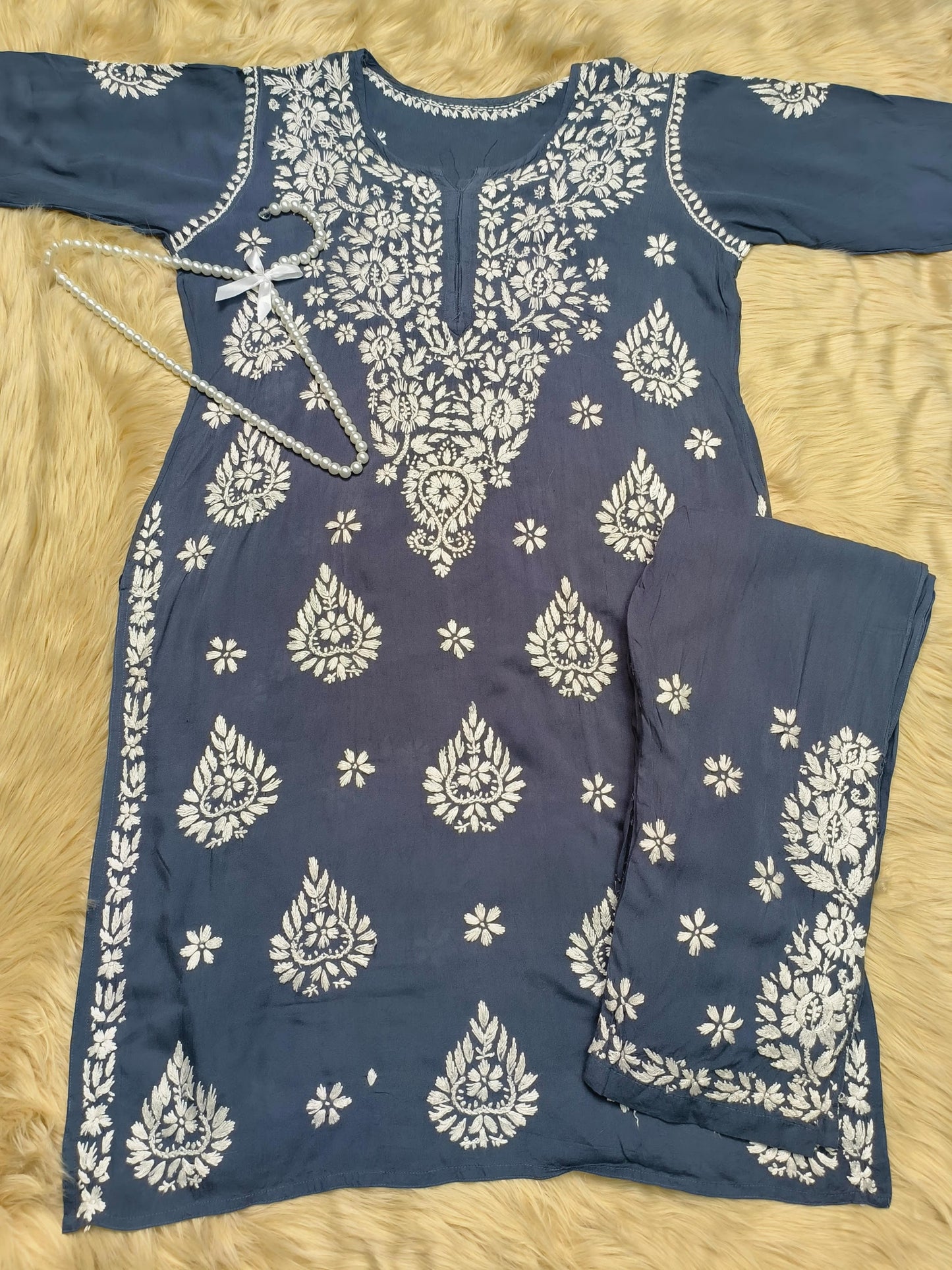 Indigo blue rayon chikankari kurta and pant set with white floral embroidery displayed on fur background
