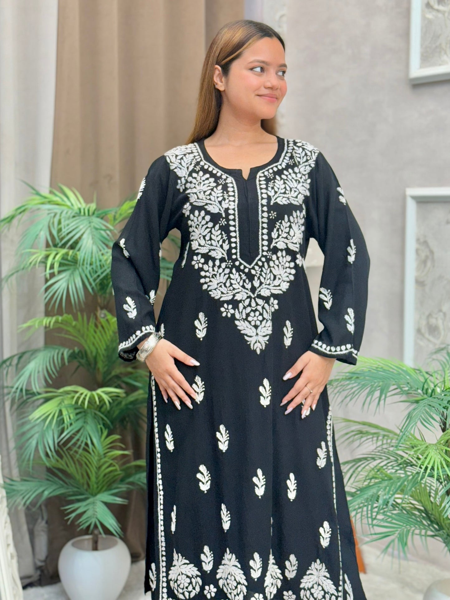 Woman wearing a black rayon chikankari kurta and pant set with white hand embroidery