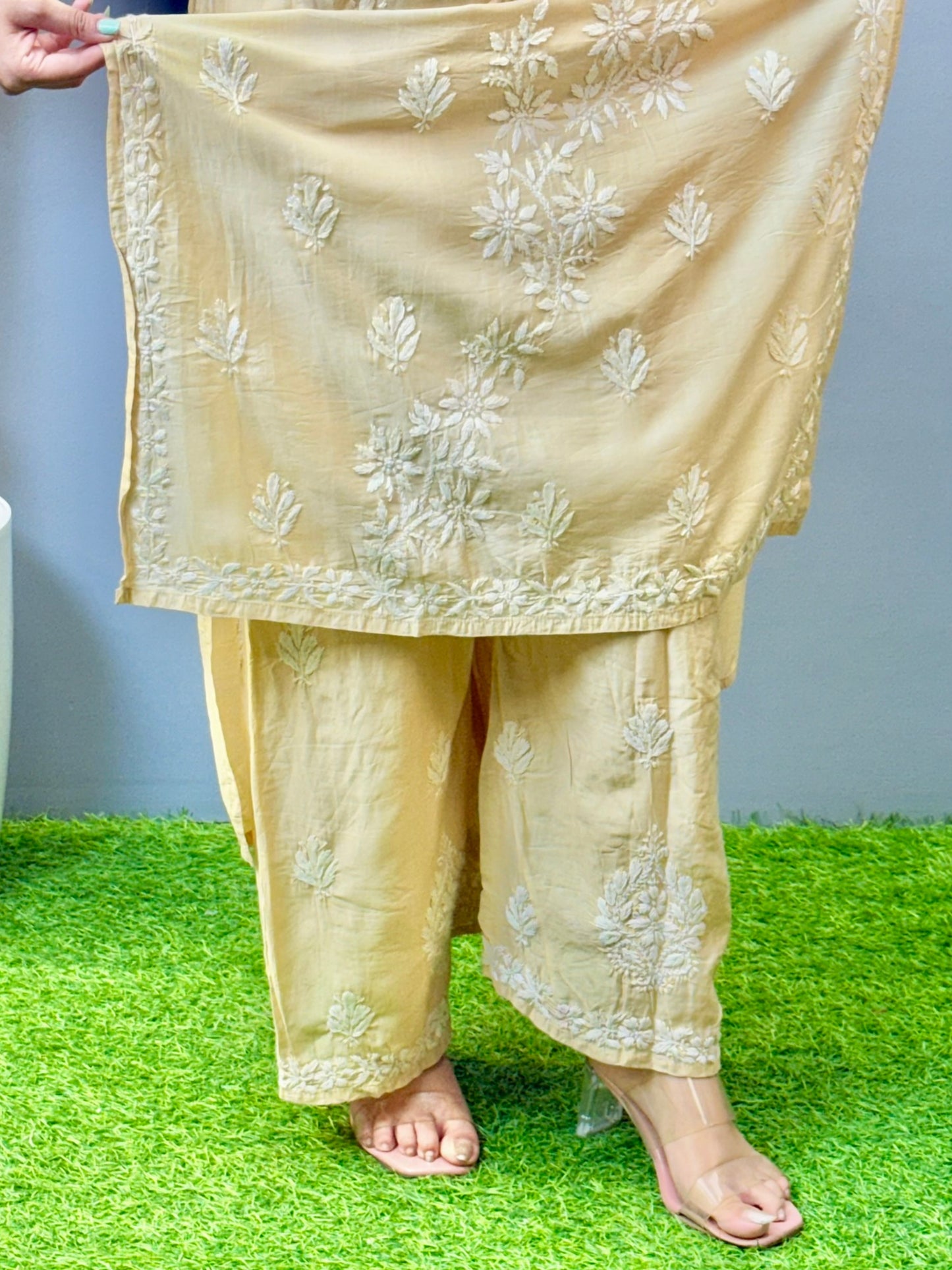 Woman wearing beige golden Chikankari kurta and palazzo set with elegant hand embroidery in chanderi fabric