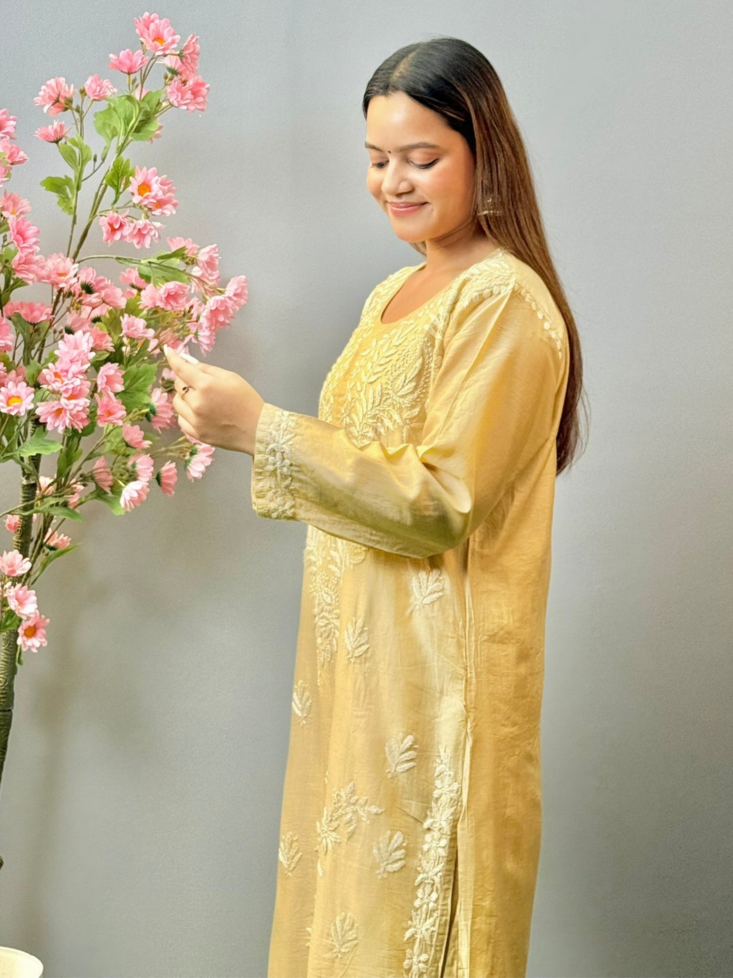 Woman wearing beige golden Chikankari kurta and palazzo set with elegant hand embroidery in chanderi fabric