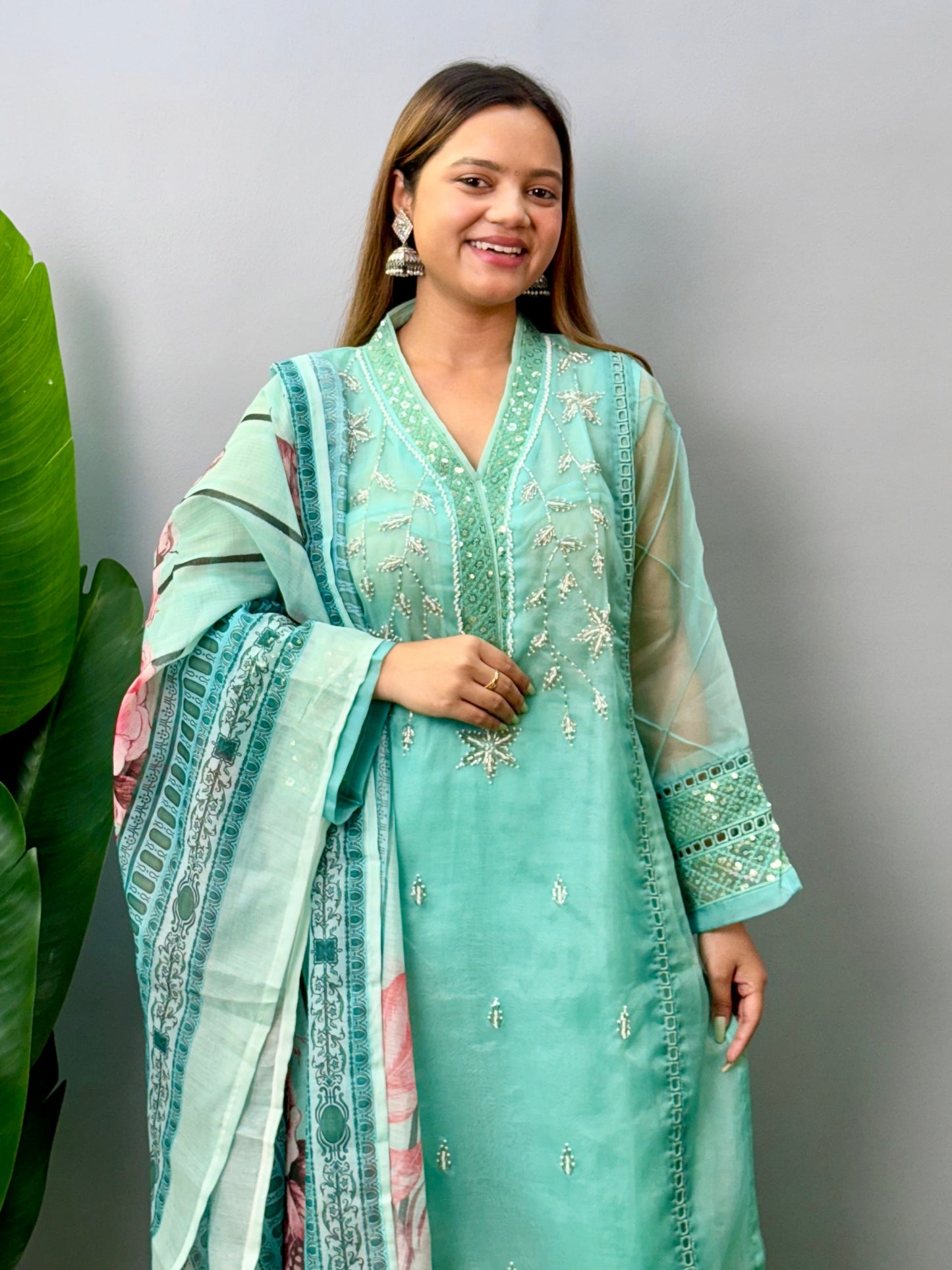 Model wearing a mint green organza kurta with rayon pants and printed cotton dupatta – Designer Wear Collection.