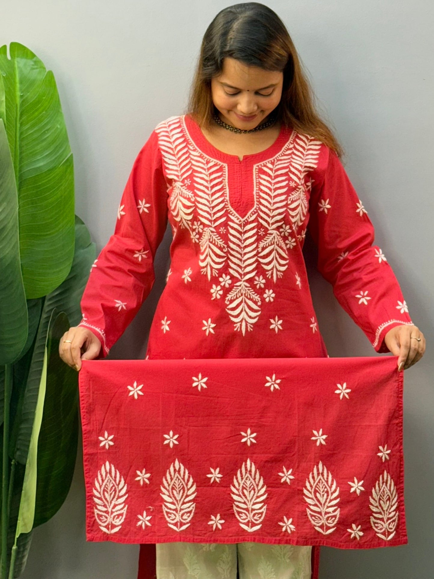 Model wearing a premium red cotton Lucknowi chikankari kurta with white hand embroidery