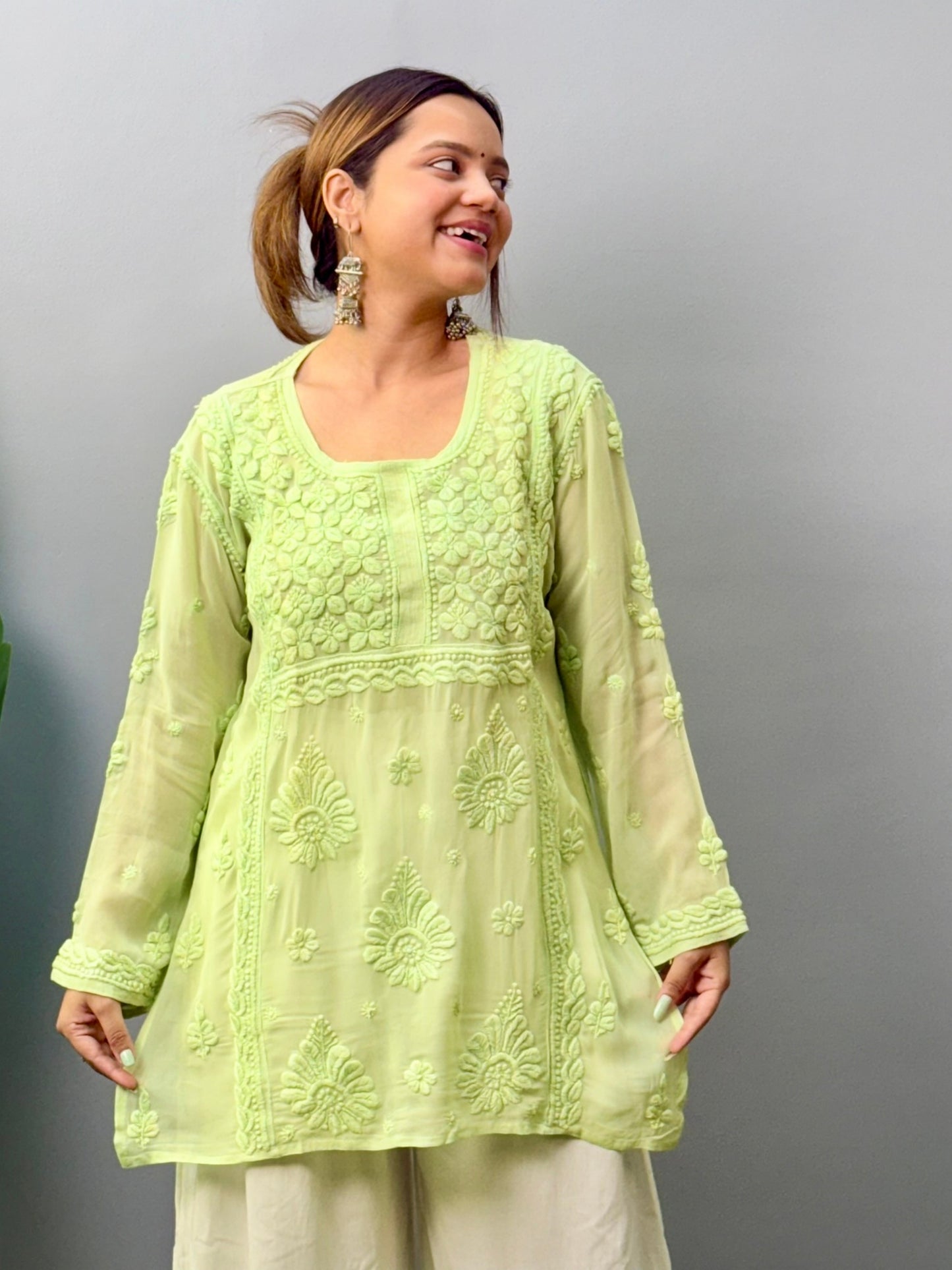 Woman in pista green short Lucknowi chikankari kurta with 3D embroidery on translucent viscose fabric