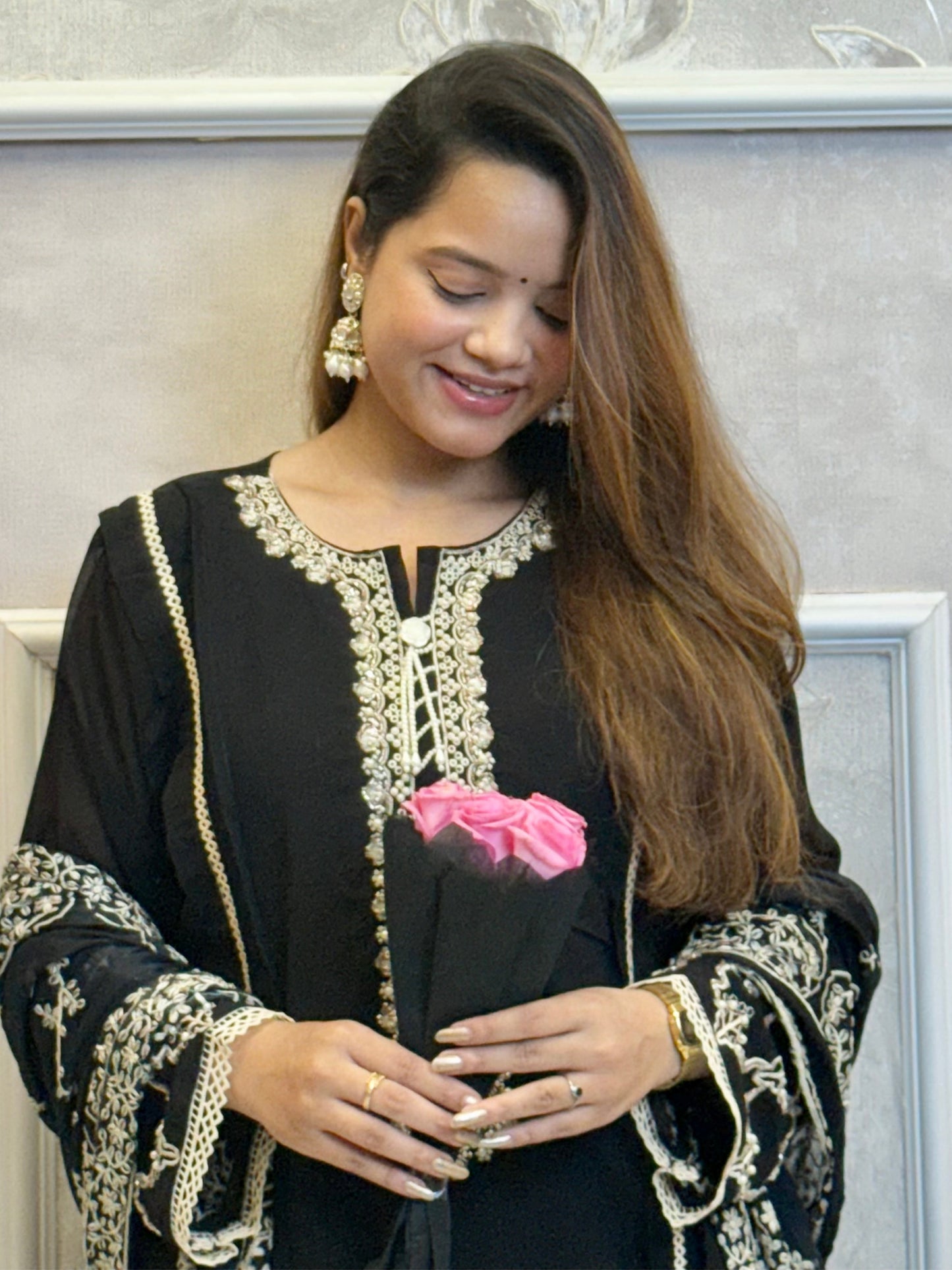 Model wearing a black georgette kurta with lycra stretchable pants and embroidered georgette dupatta with tassels – Designer Wear Collection.