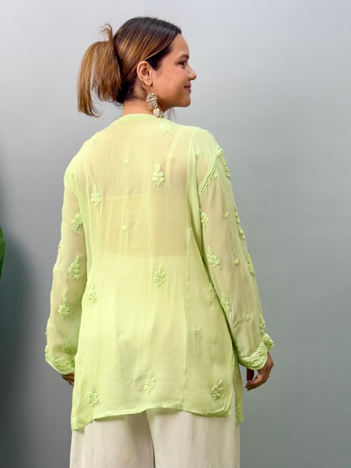 Woman in pista green short Lucknowi chikankari kurta with 3D embroidery on translucent viscose fabric