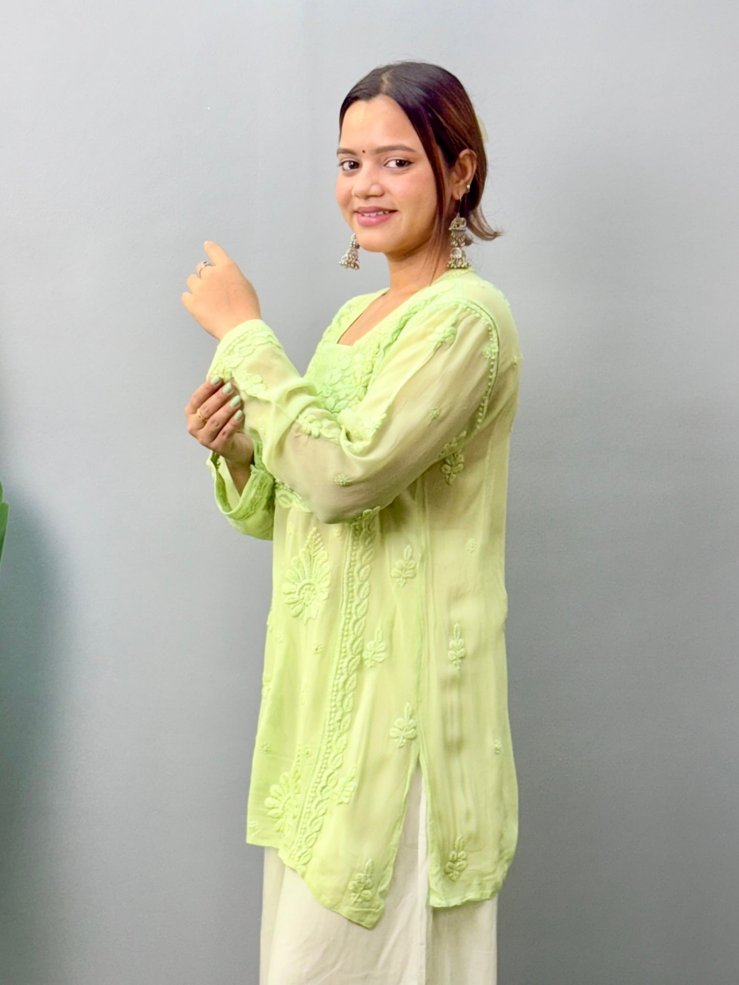 Woman in pista green short Lucknowi chikankari kurta with 3D embroidery on translucent viscose fabric