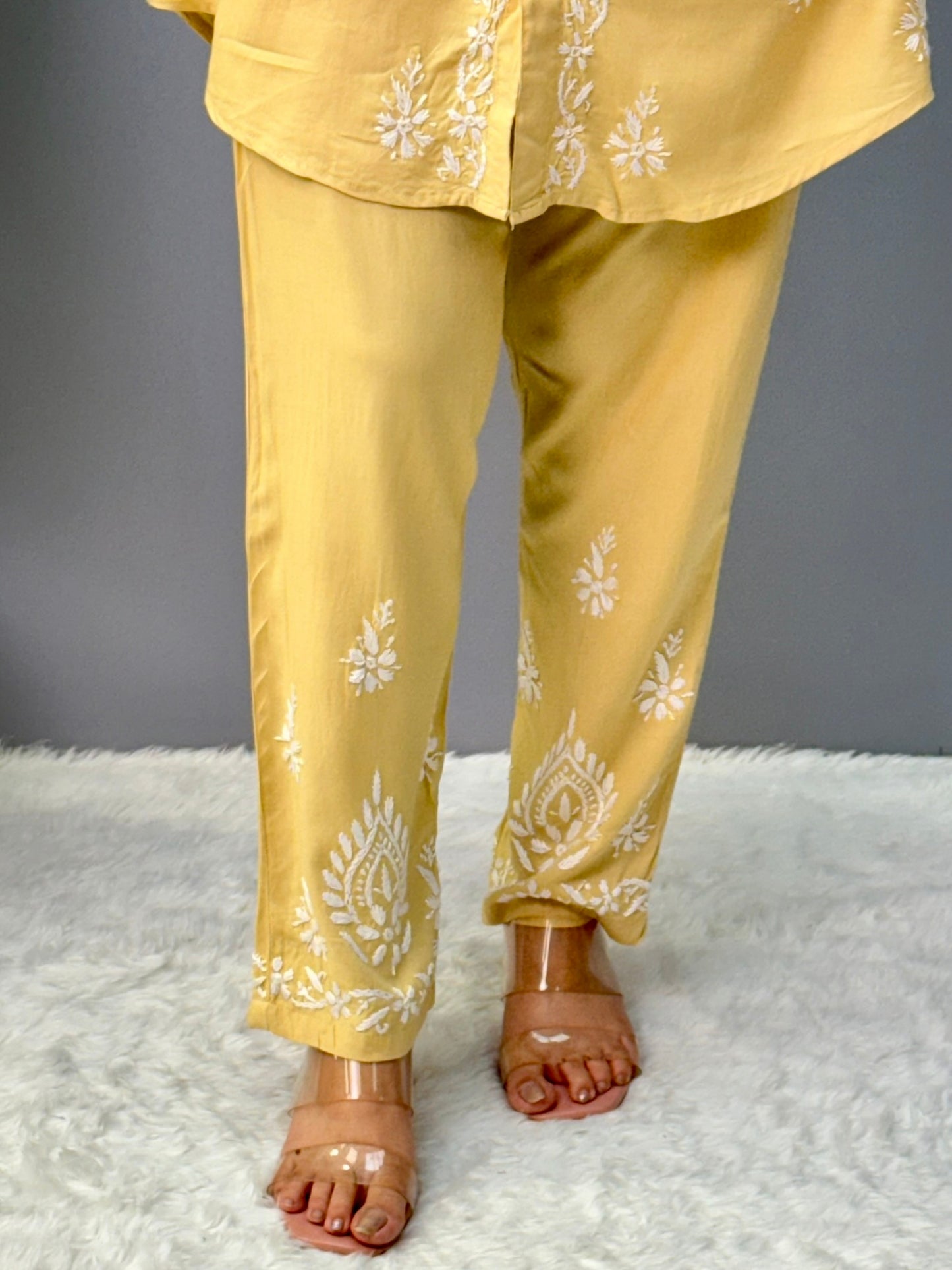 Woman in lemon yellow chikankari coord set with collared kurta and embroidered pants