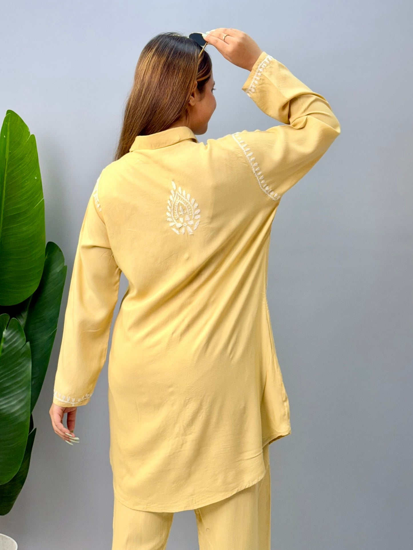Woman in lemon yellow chikankari coord set with collared kurta and embroidered pants