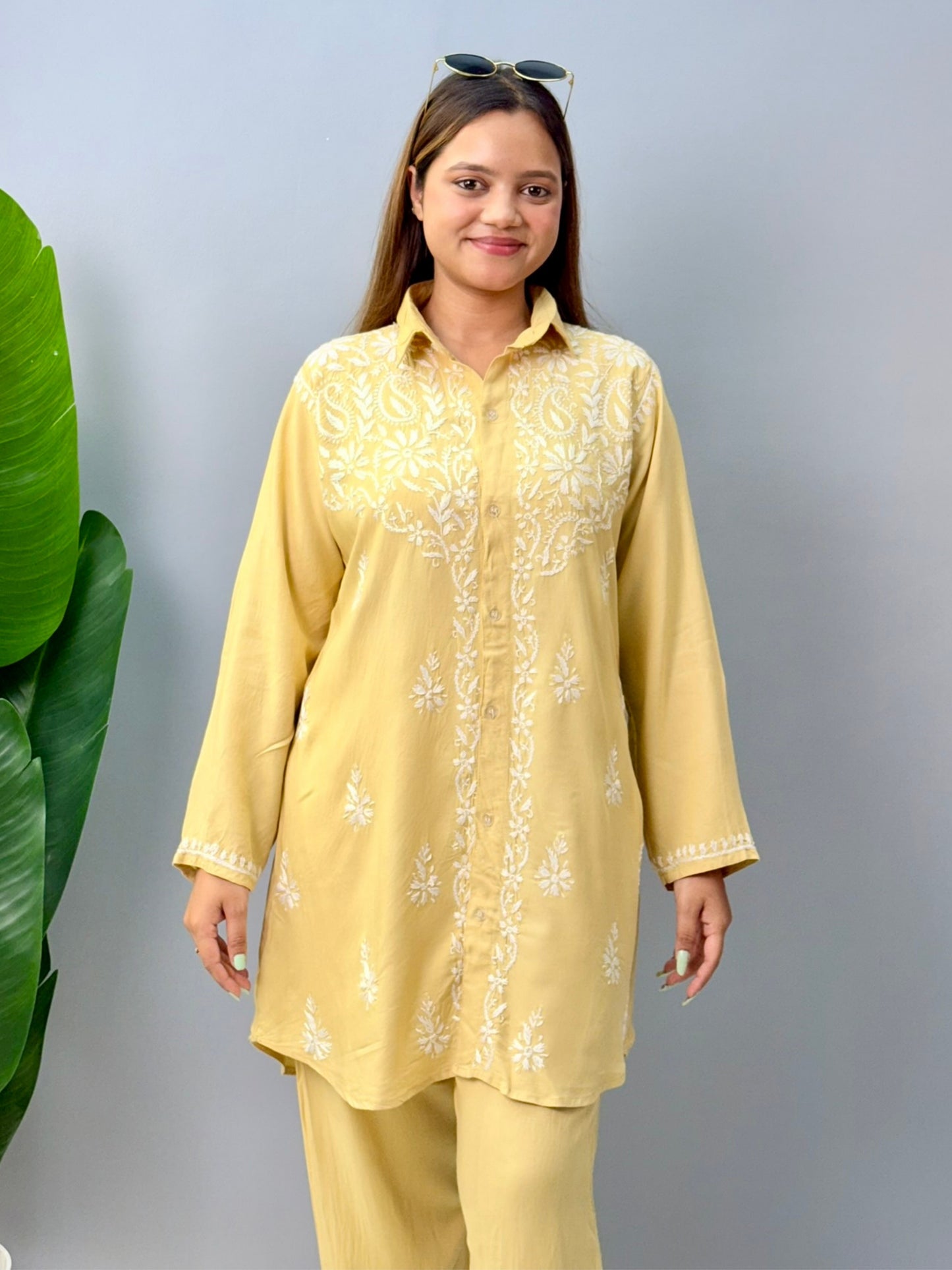 Woman in lemon yellow chikankari coord set with collared kurta and embroidered pants