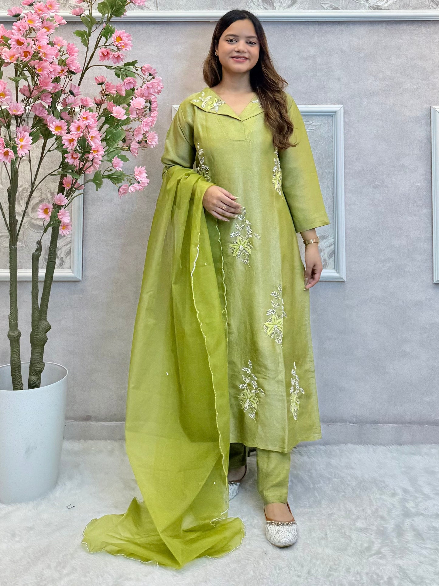 Model wearing an olive green tissue silk kurta with hand embroidery, paired with tissue silk pants and an organza dupatta – Designer Wear Collection.