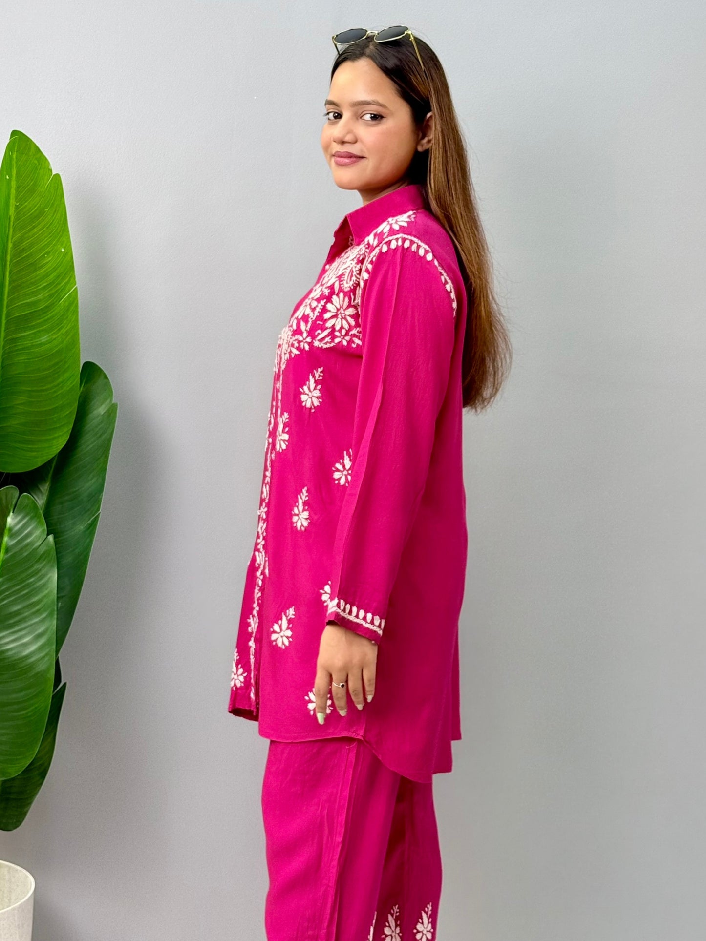 Woman wearing dark pink chikankari coord set with collared kurta and embroidered pants