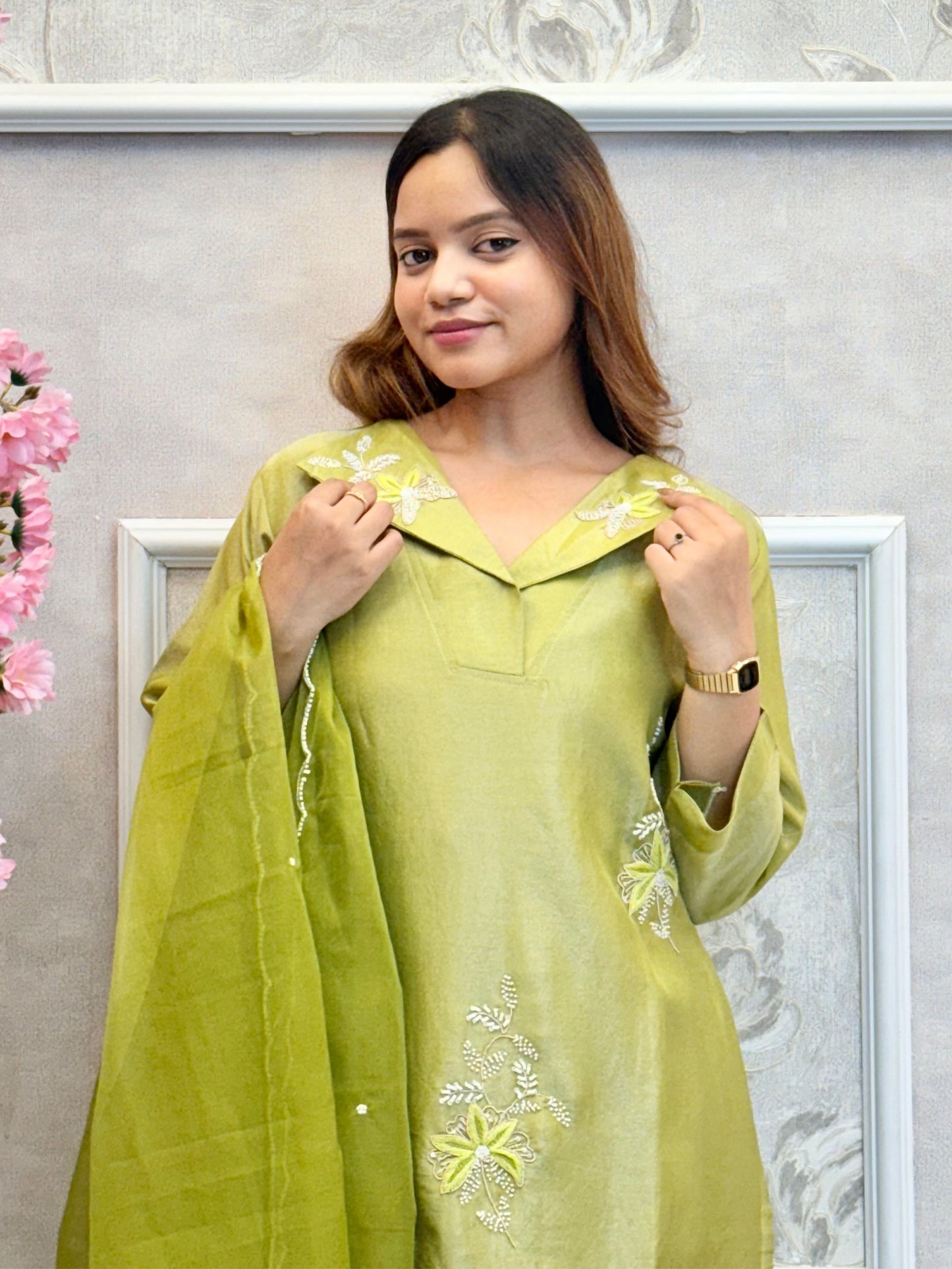 Model wearing an olive green tissue silk kurta with hand embroidery, paired with tissue silk pants and an organza dupatta – Designer Wear Collection.