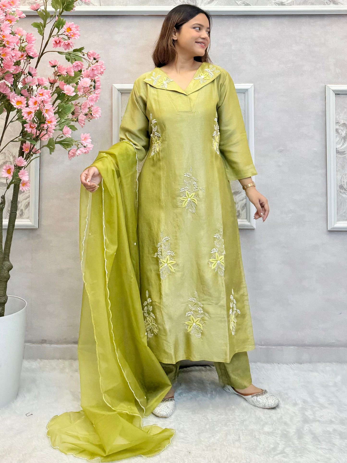 Model wearing an olive green tissue silk kurta with hand embroidery, paired with tissue silk pants and an organza dupatta – Designer Wear Collection.