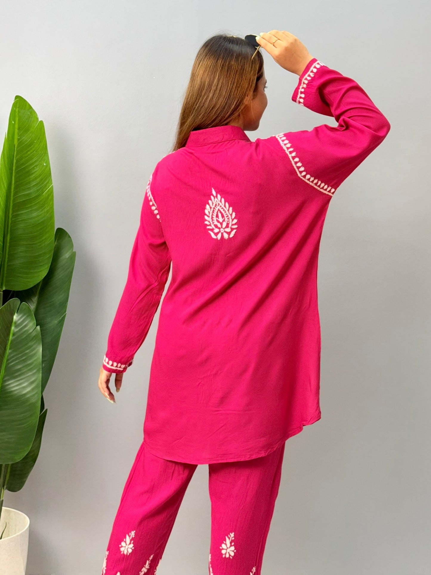 Woman wearing dark pink chikankari coord set with collared kurta and embroidered pants