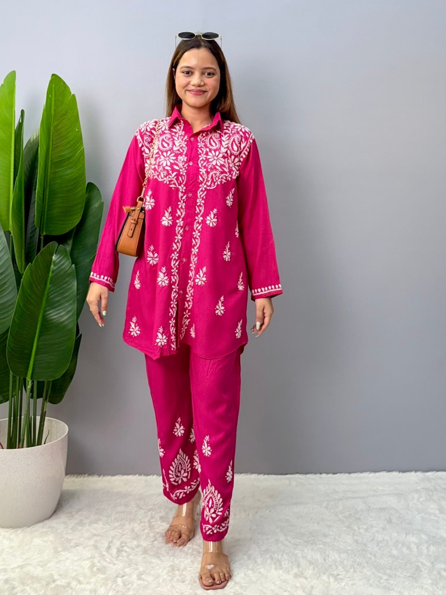 Woman wearing dark pink chikankari coord set with collared kurta and embroidered pants