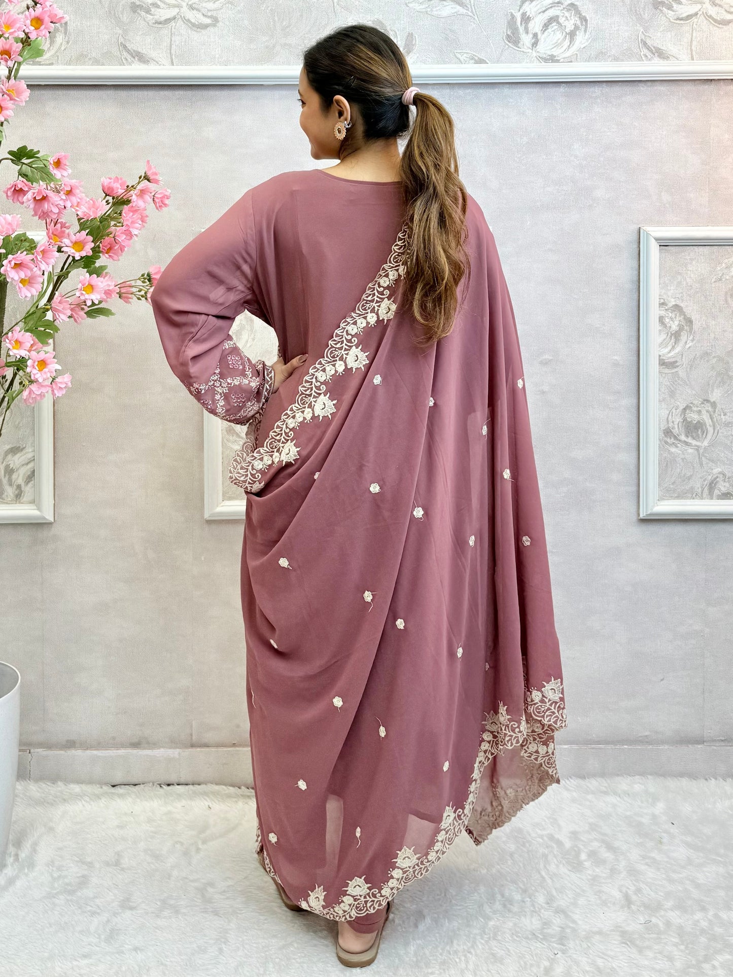 Model wearing a mauve georgette embroidered kurta with lycra stretchable pants and embroidered georgette dupatta – Designer Wear Collection.