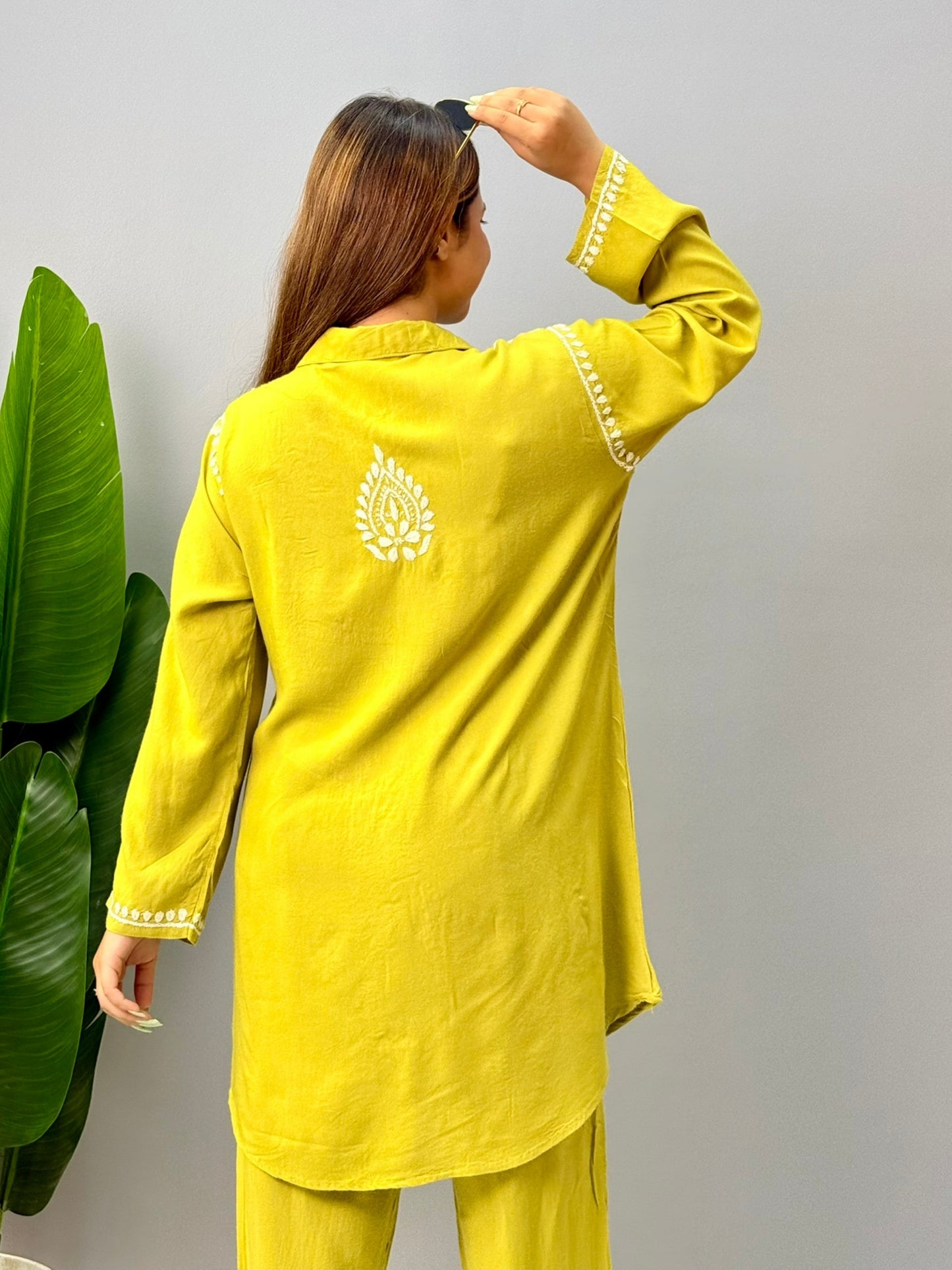 Woman wearing mustard lime chikankari coord set with embroidered kurta and pant