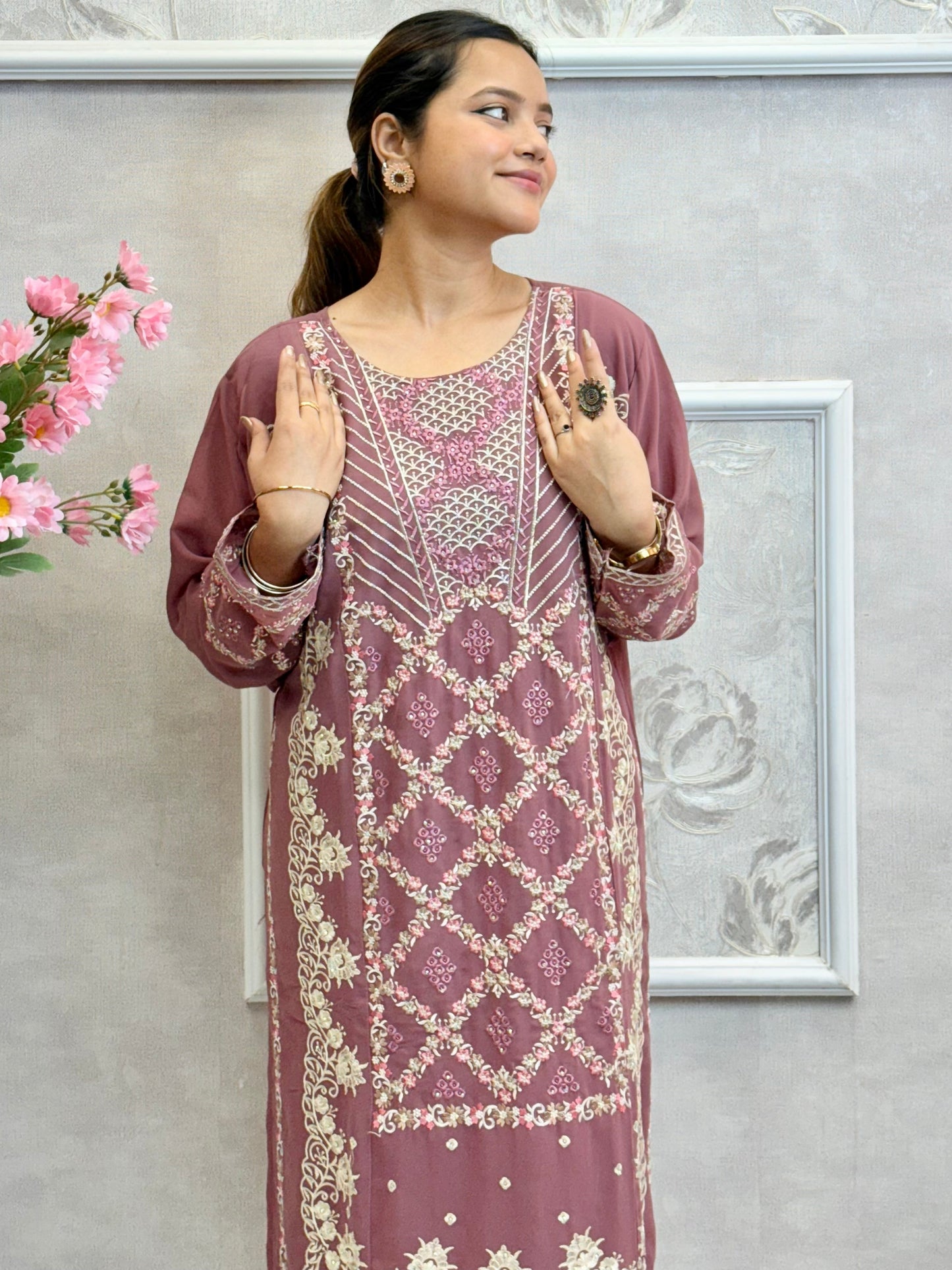 Model wearing a mauve georgette embroidered kurta with lycra stretchable pants and embroidered georgette dupatta – Designer Wear Collection.