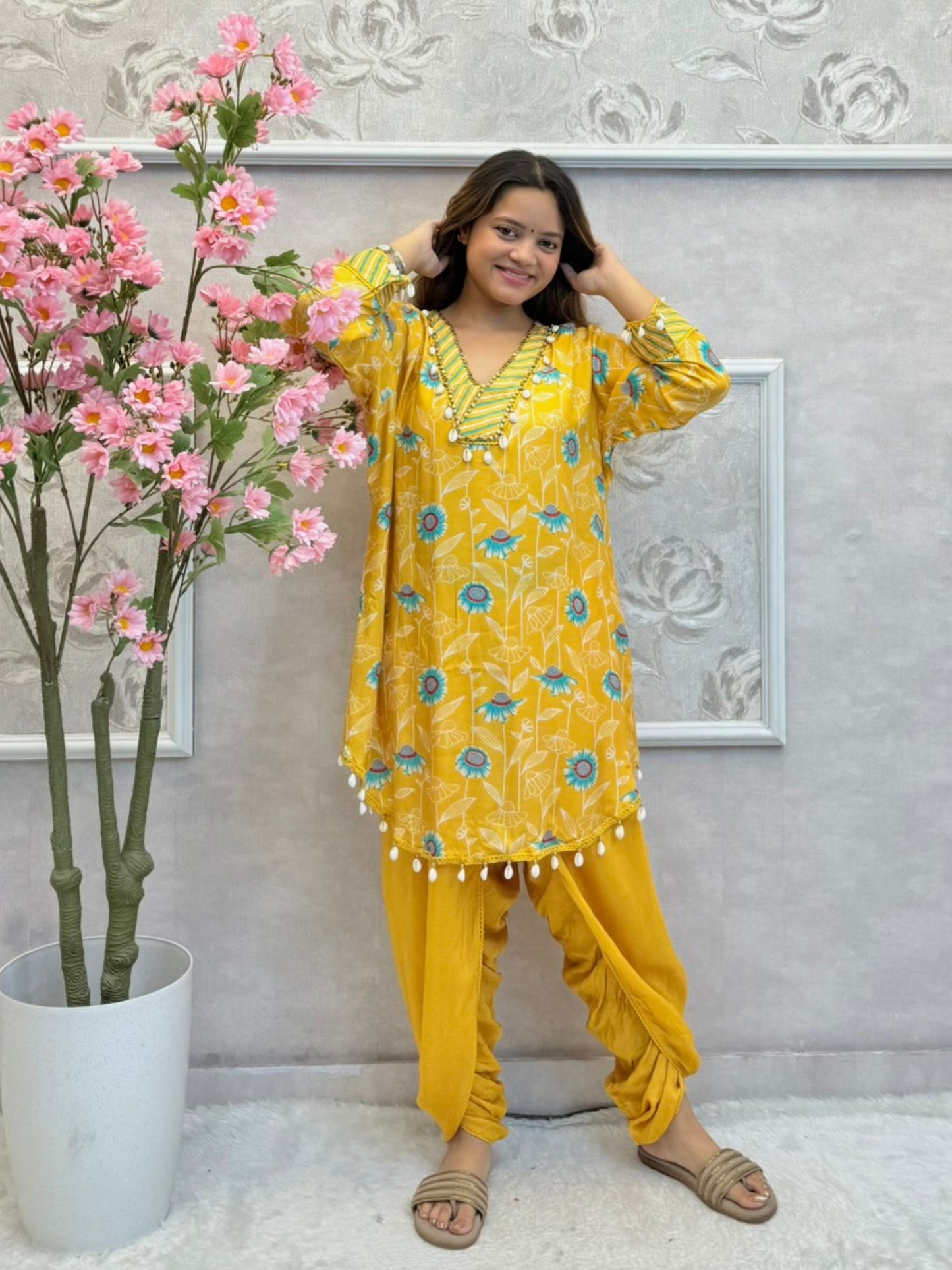 Yellow floral muslin kurta with dhoti pant set featuring shell work and printed design