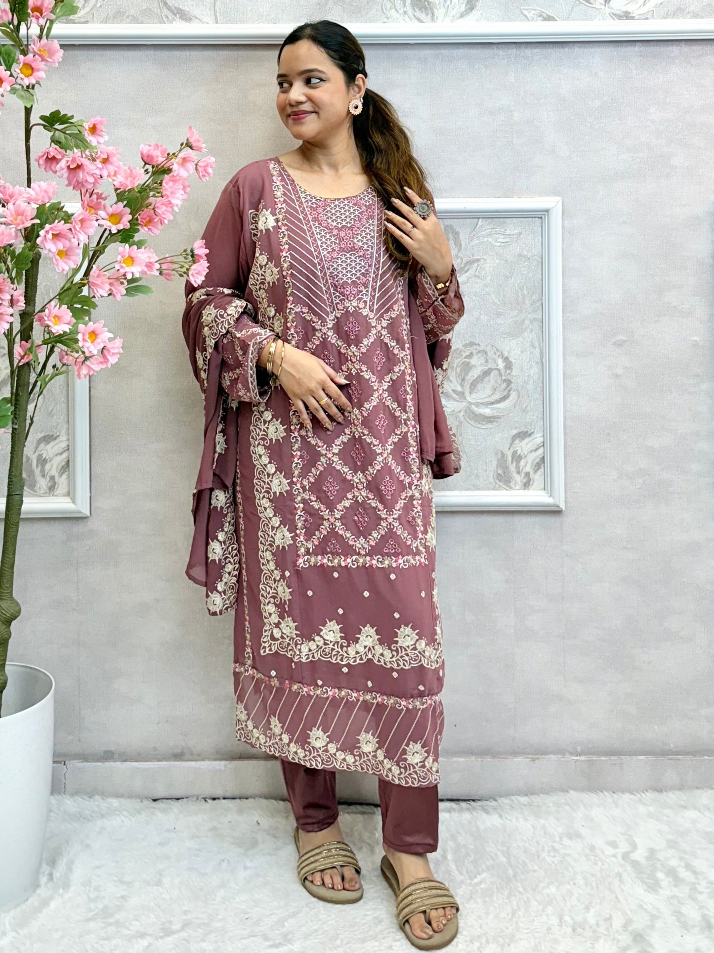 Model wearing a mauve georgette embroidered kurta with lycra stretchable pants and embroidered georgette dupatta – Designer Wear Collection.