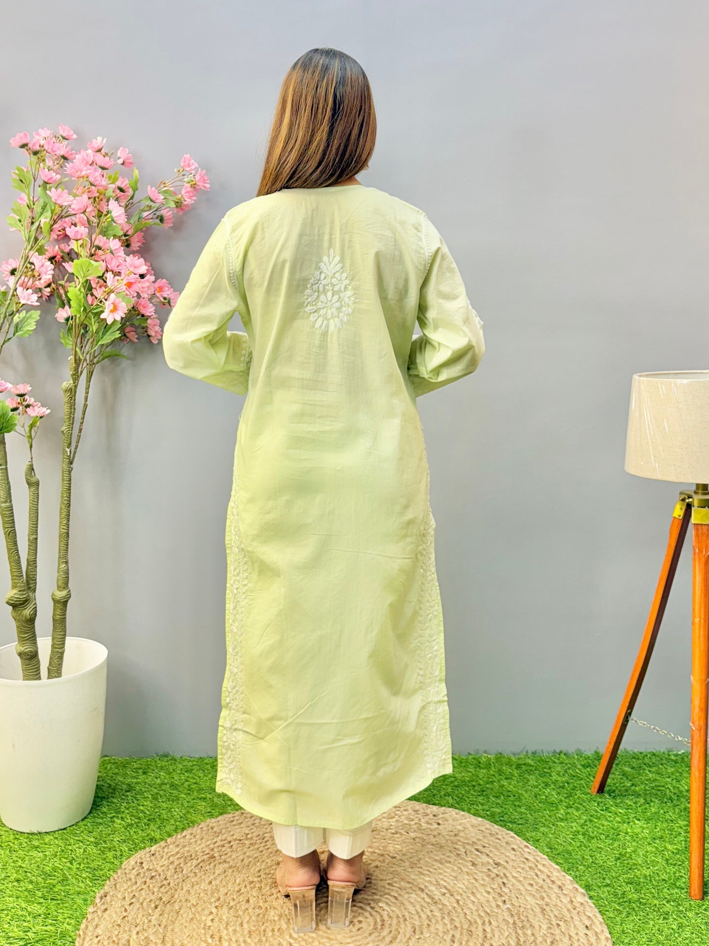 Woman wearing a premium quality light pistachio green cotton Lucknowi Chikankari kurta with white hand embroidery and straight cut, full sleeves, by R S CHIKANKARI.
