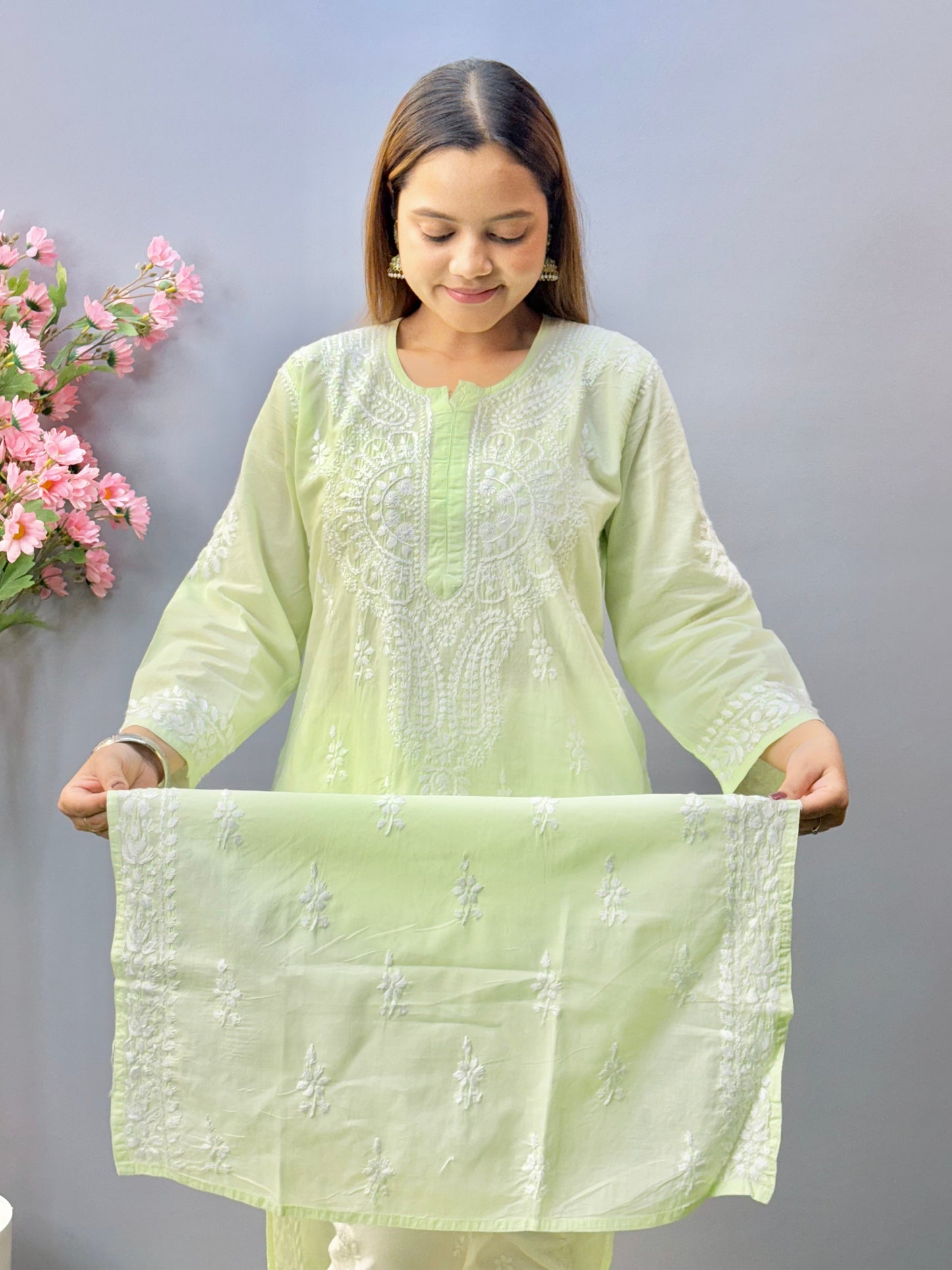 Woman wearing a premium quality light pistachio green cotton Lucknowi Chikankari kurta with white hand embroidery and straight cut, full sleeves, by R S CHIKANKARI.