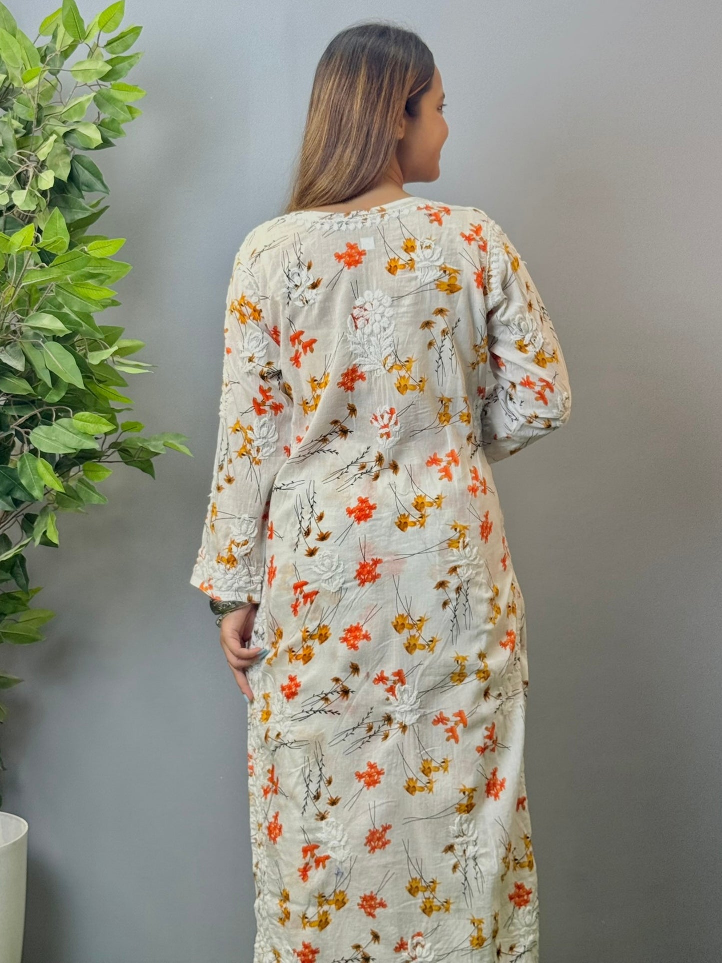 Model wearing ivory floral printed mulmul chikankari kurta and palazzo set with detailed 3D embroidery.