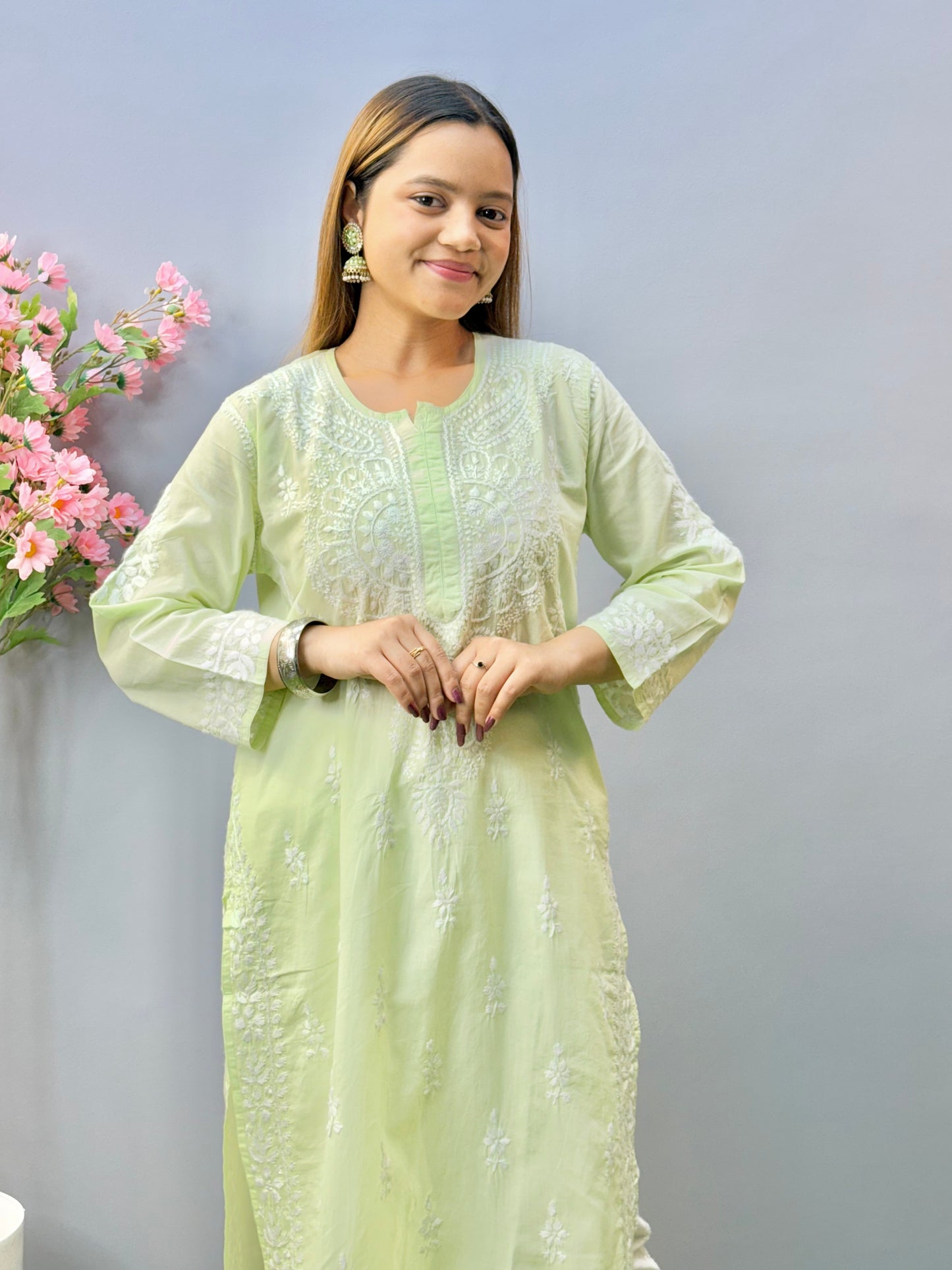 Woman wearing a premium quality light pistachio green cotton Lucknowi Chikankari kurta with white hand embroidery and straight cut, full sleeves, by R S CHIKANKARI.