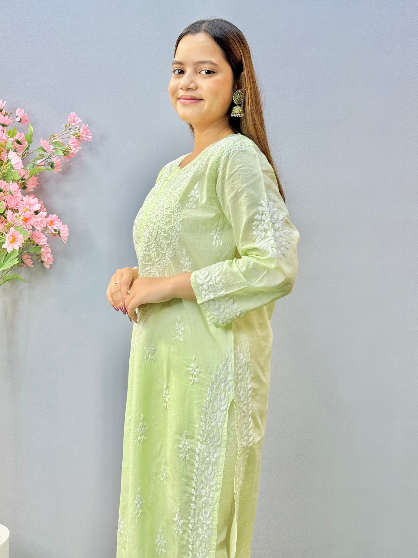 Woman wearing a premium quality light pistachio green cotton Lucknowi Chikankari kurta with white hand embroidery and straight cut, full sleeves, by R S CHIKANKARI.