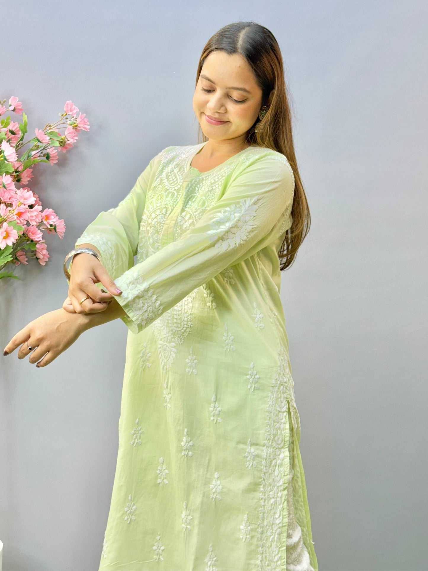 Woman wearing a premium quality light pistachio green cotton Lucknowi Chikankari kurta with white hand embroidery and straight cut, full sleeves, by R S CHIKANKARI.