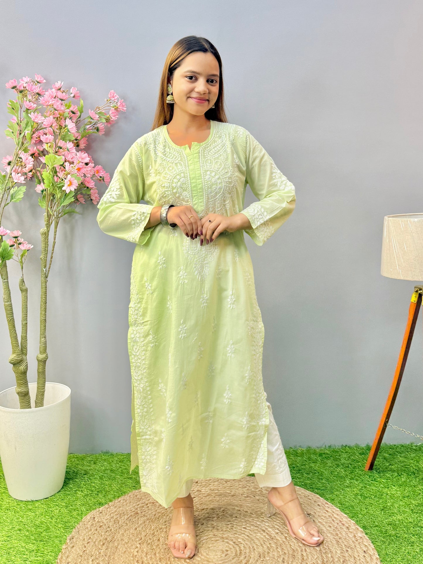 Woman wearing a premium quality light pistachio green cotton Lucknowi Chikankari kurta with white hand embroidery and straight cut, full sleeves, by R S CHIKANKARI.