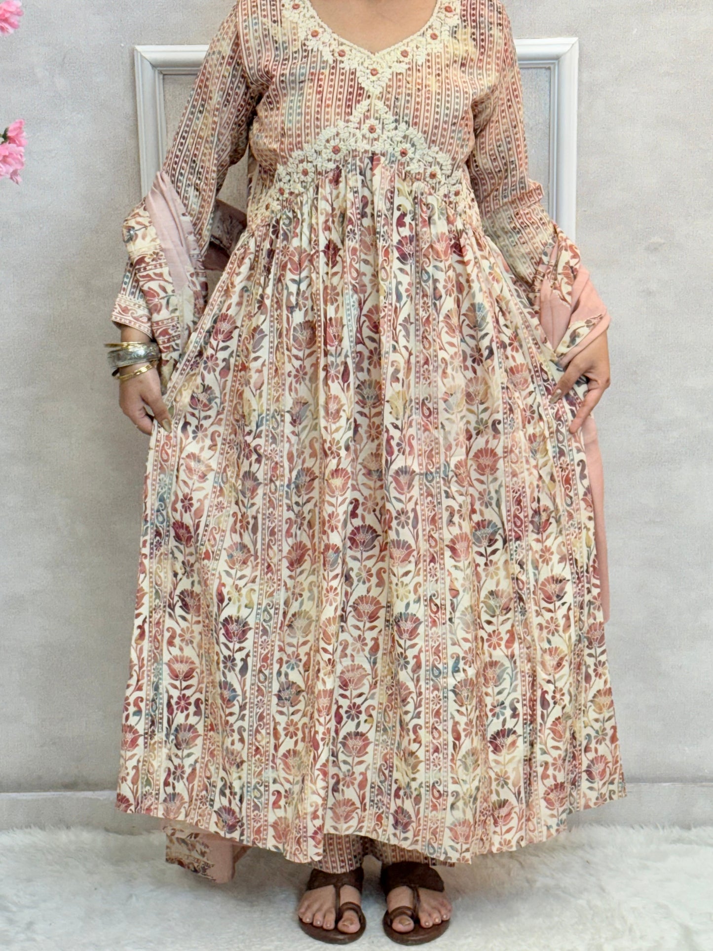 Model wearing a dusty rose floral long flared chanderi silk dress with hand embroidery – Designer Wear Collection.