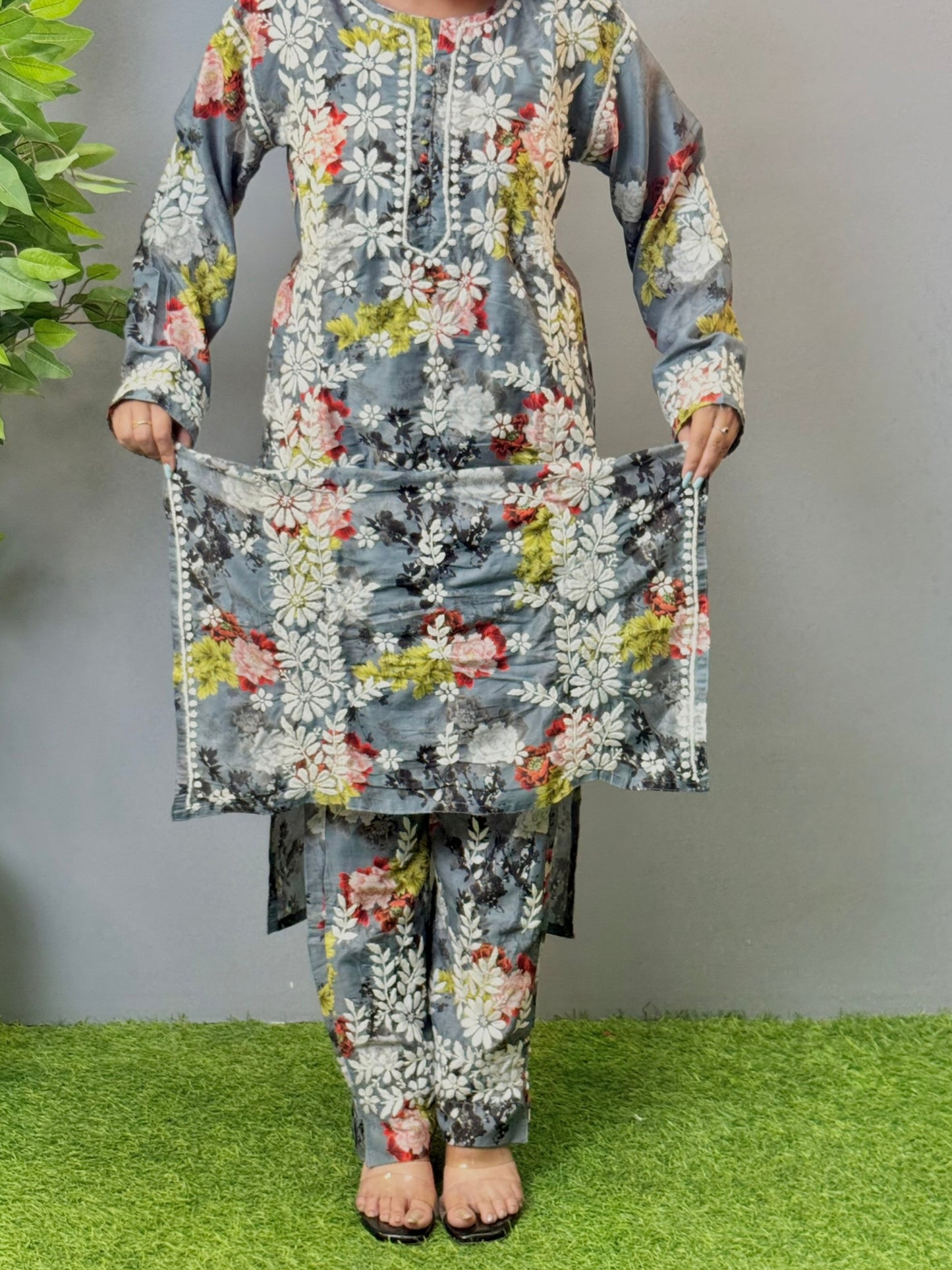 Model wearing charcoal floral muslin kurta and pant set with white Lucknowi chikankari and 3D hand embroidery.