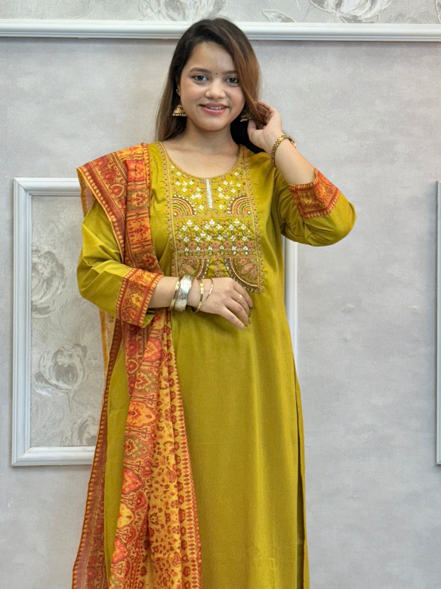 Model wearing a mustard yellow chanderi kurta with hand embroidery, paired with chanderi pants and a red-golden woven chanderi dupatta – Designer Wear Collection.