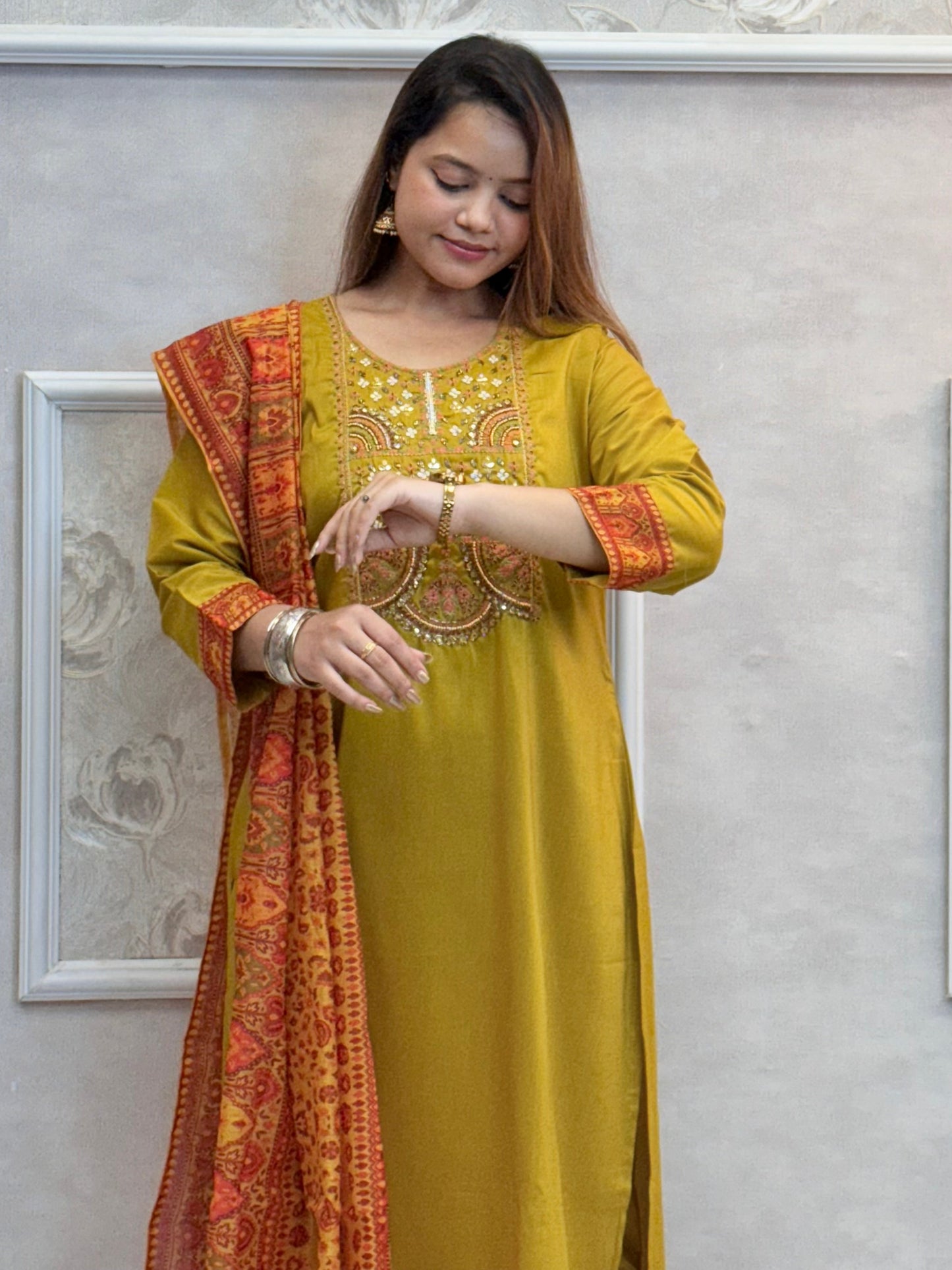 Model wearing a mustard yellow chanderi kurta with hand embroidery, paired with chanderi pants and a red-golden woven chanderi dupatta – Designer Wear Collection.
