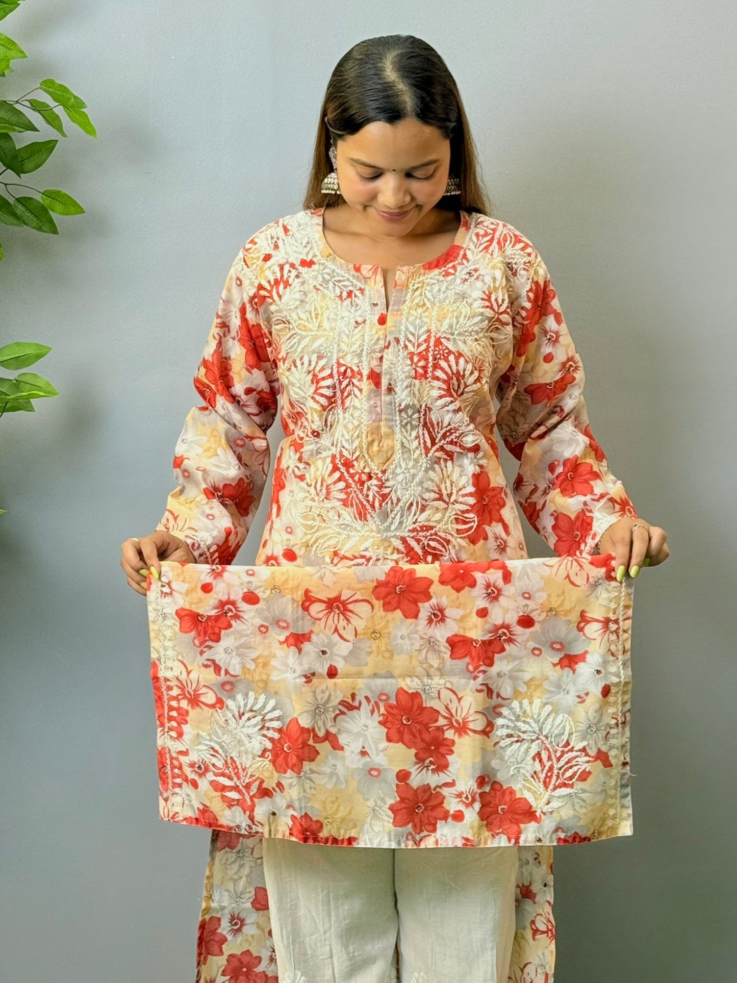 Model wearing beige and red floral chikankari kurta in crape fabric with white embroidery