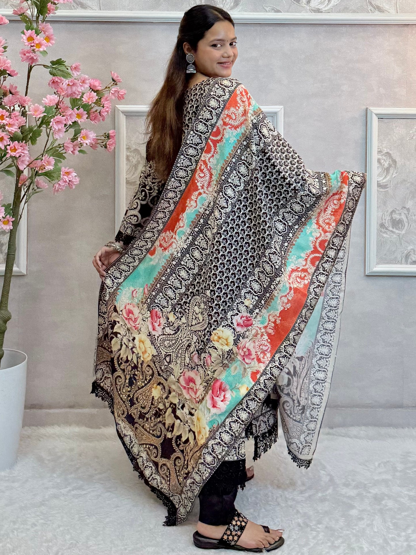 Model wearing a black printed mulmul kurta with mulmul pants and a multicolor printed mulmul dupatta – Designer Wear Collection.