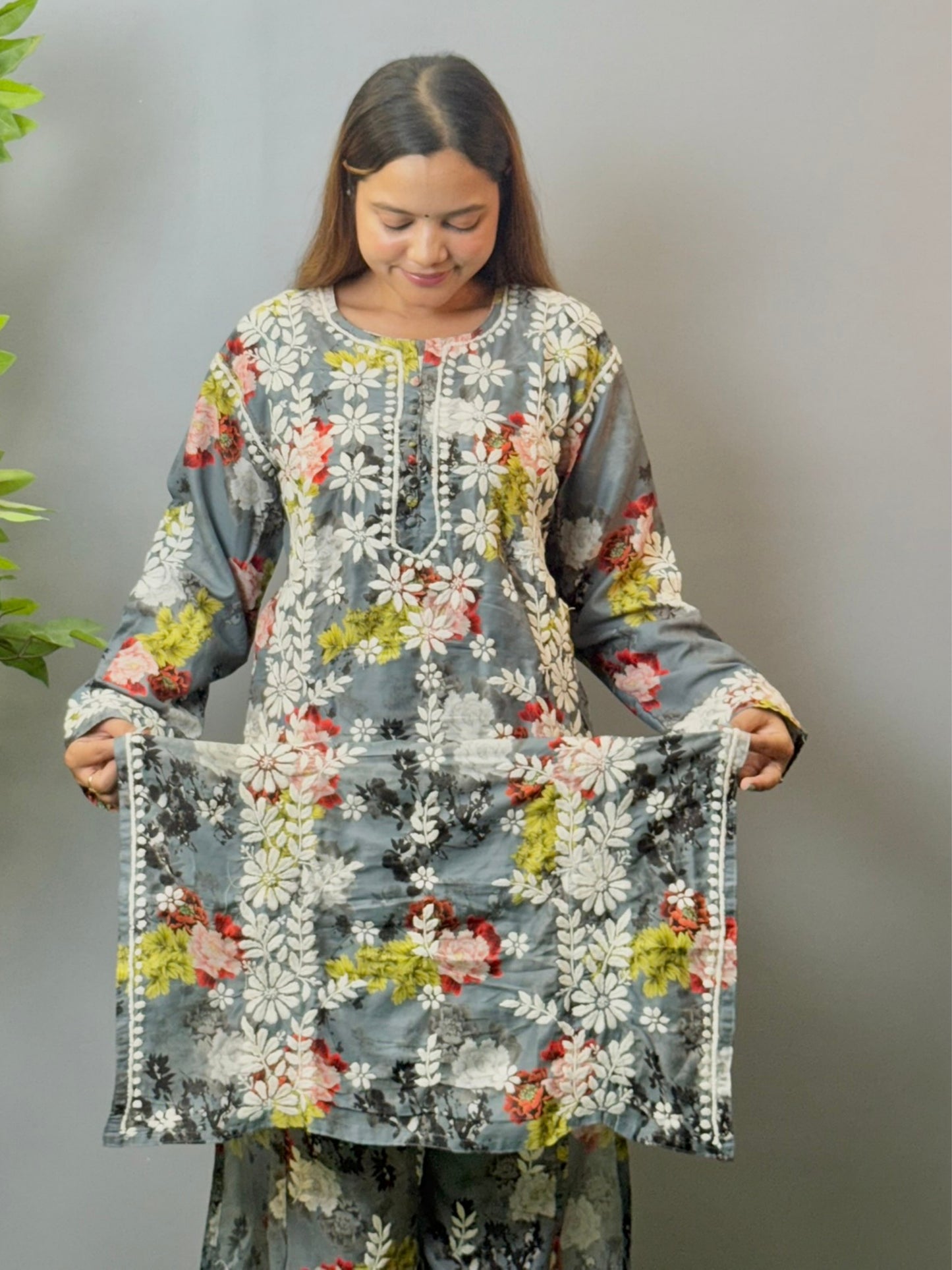 Model wearing charcoal floral muslin kurta and pant set with white Lucknowi chikankari and 3D hand embroidery.