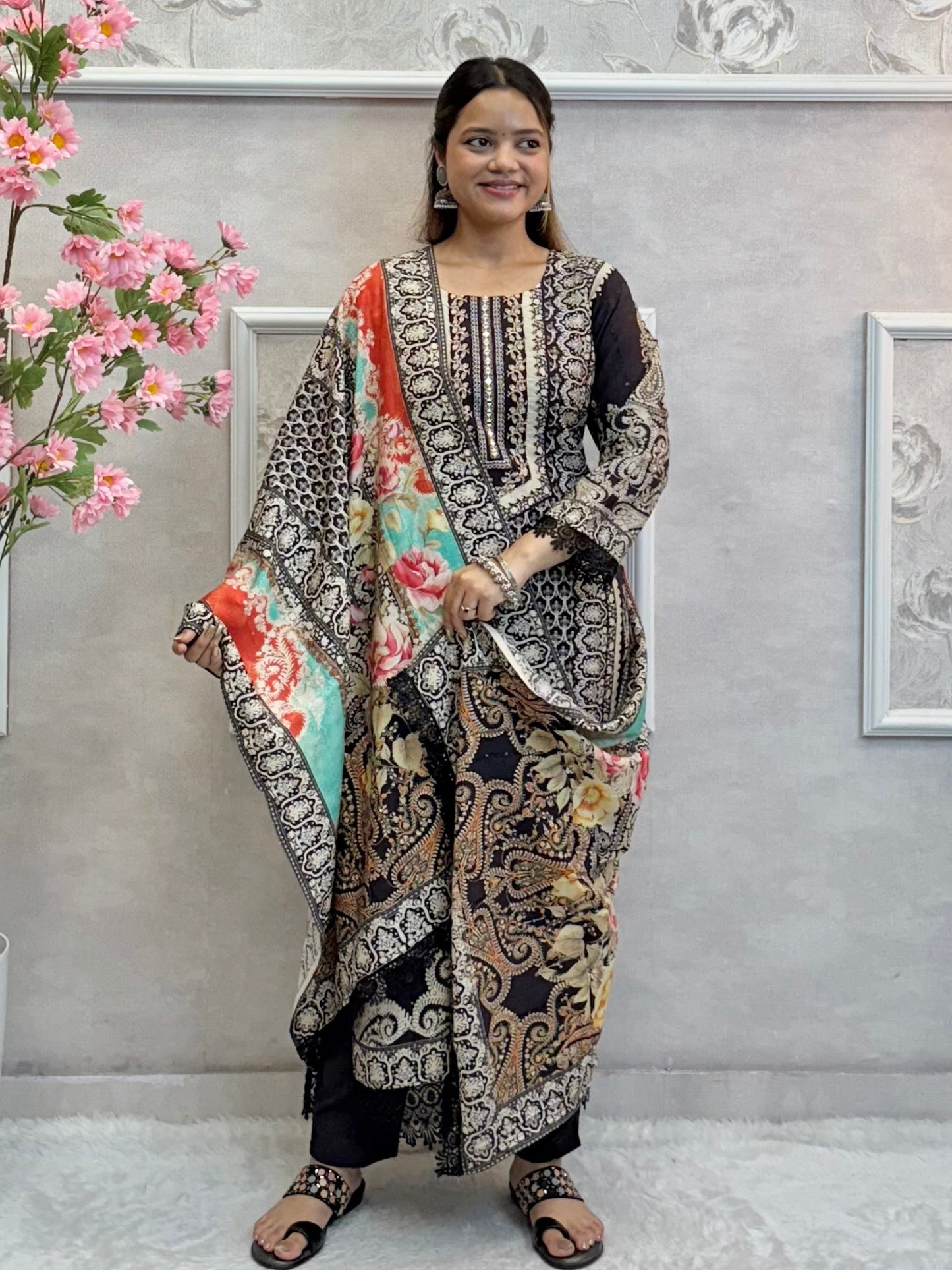 Model wearing a black printed mulmul kurta with mulmul pants and a multicolor printed mulmul dupatta – Designer Wear Collection.