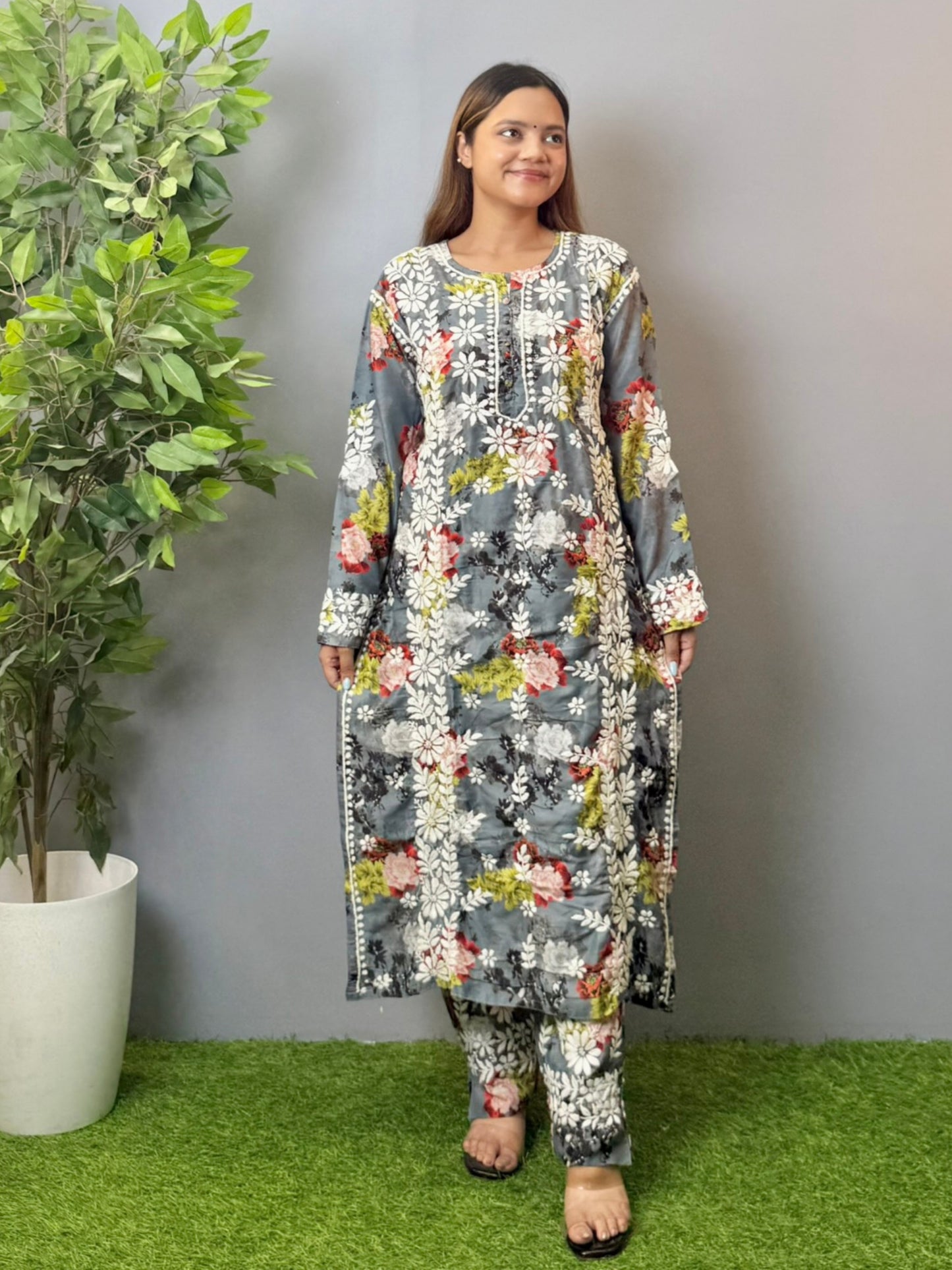 Model wearing charcoal floral muslin kurta and pant set with white Lucknowi chikankari and 3D hand embroidery.