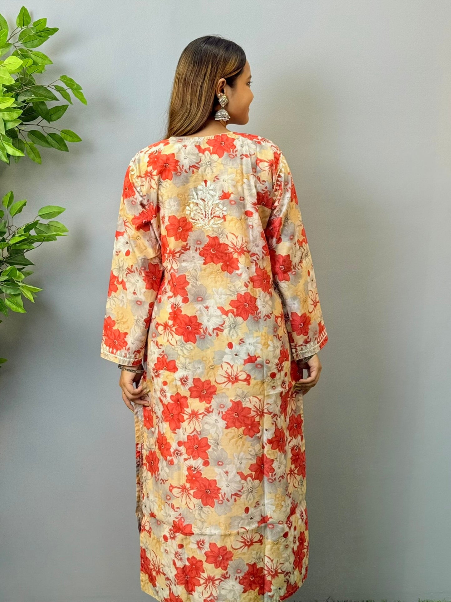 Model wearing beige and red floral chikankari kurta in crape fabric with white embroidery