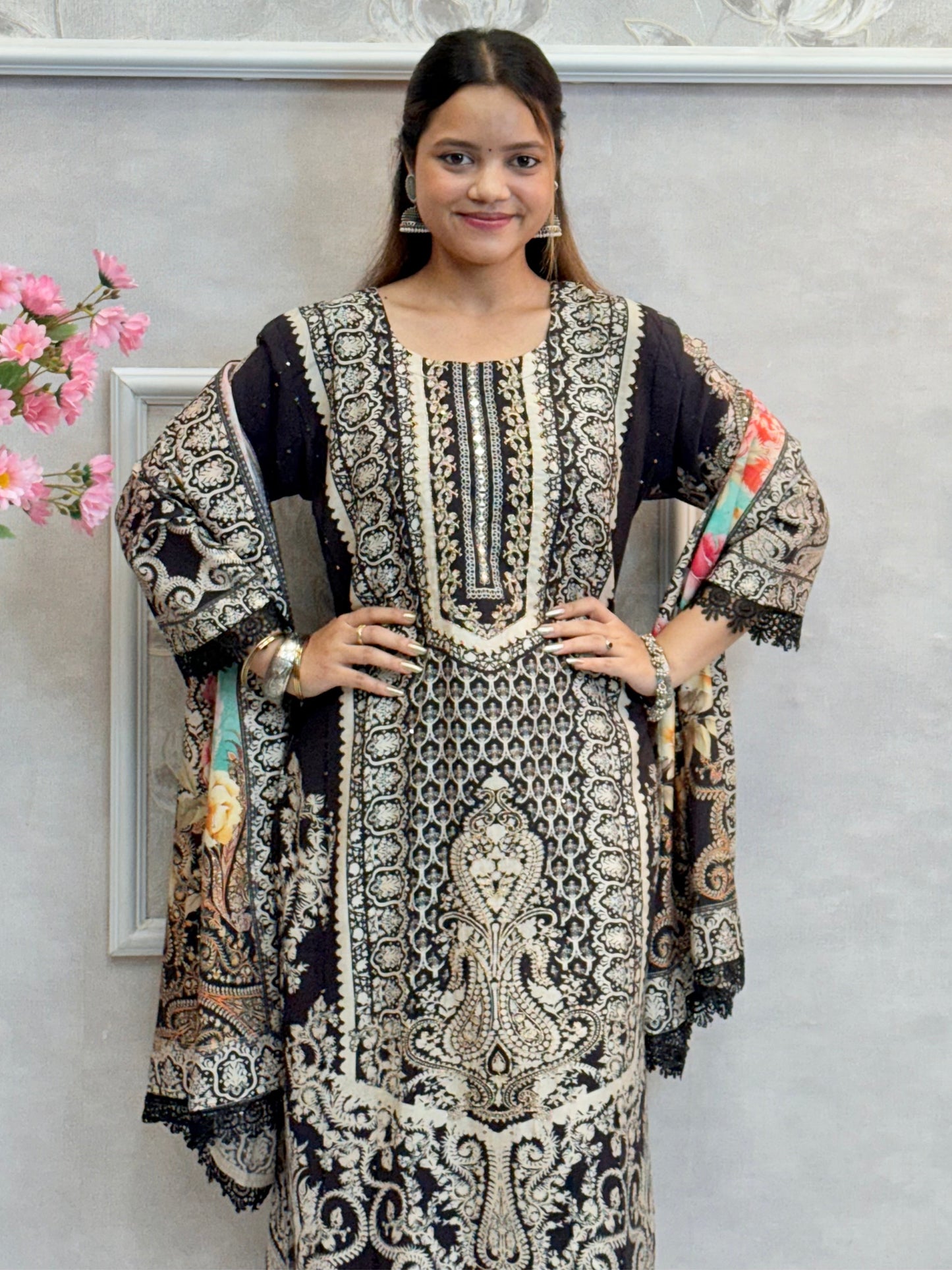 Model wearing a black printed mulmul kurta with mulmul pants and a multicolor printed mulmul dupatta – Designer Wear Collection.