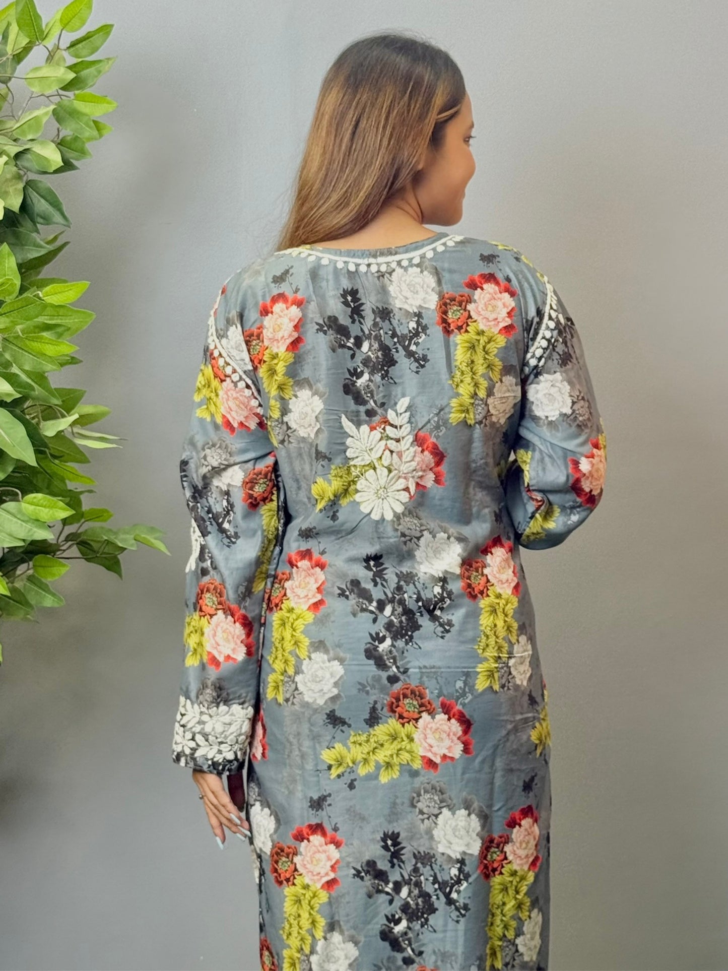 Model wearing charcoal floral muslin kurta and pant set with white Lucknowi chikankari and 3D hand embroidery.