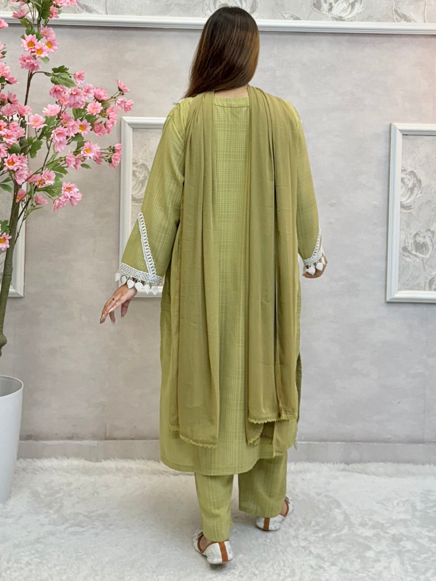Model wearing an olive green georgette kurta with lacework, paired with georgette pants and a chiffon dupatta – Designer Wear Collection.
