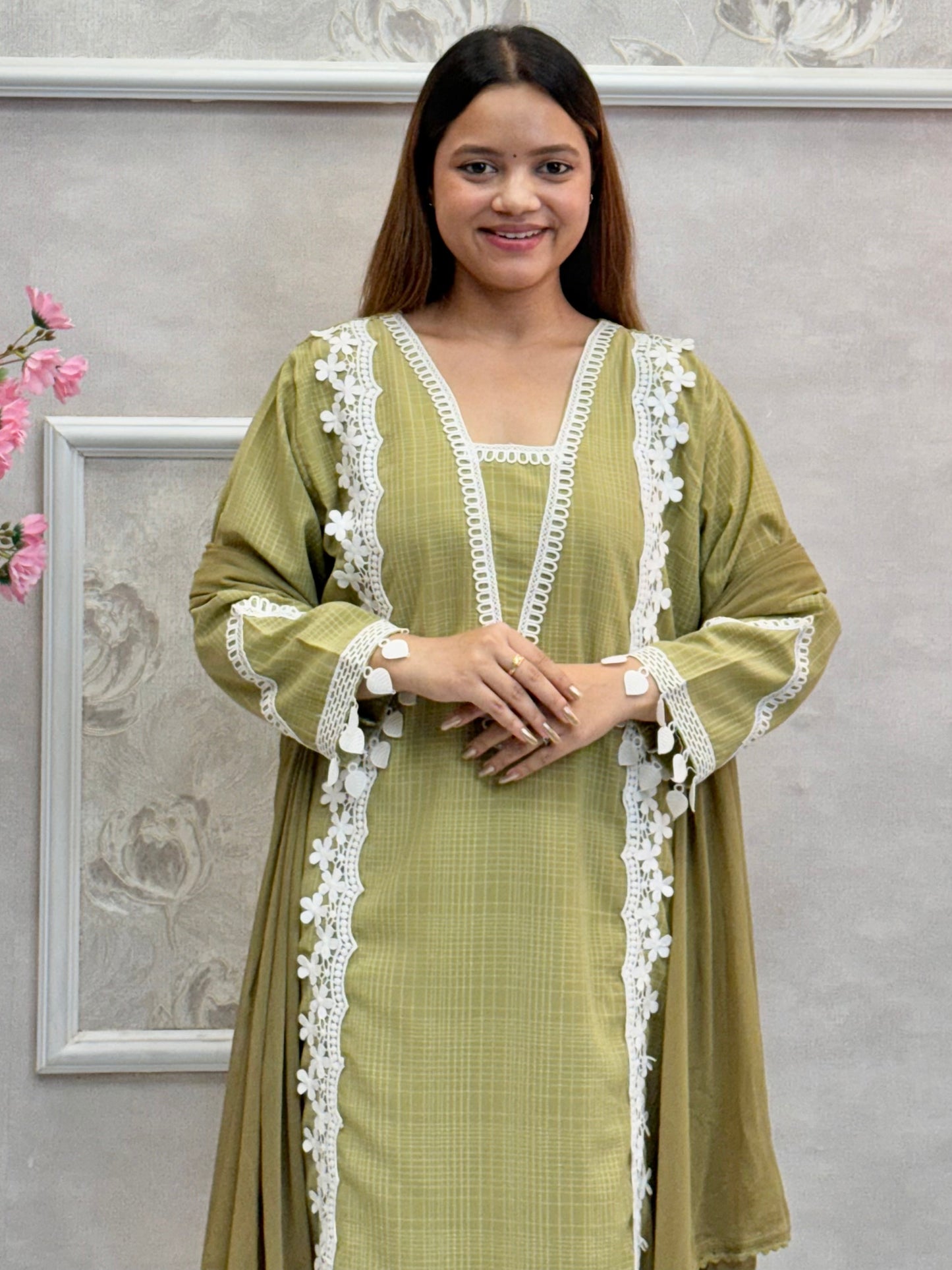 Model wearing an olive green georgette kurta with lacework, paired with georgette pants and a chiffon dupatta – Designer Wear Collection.