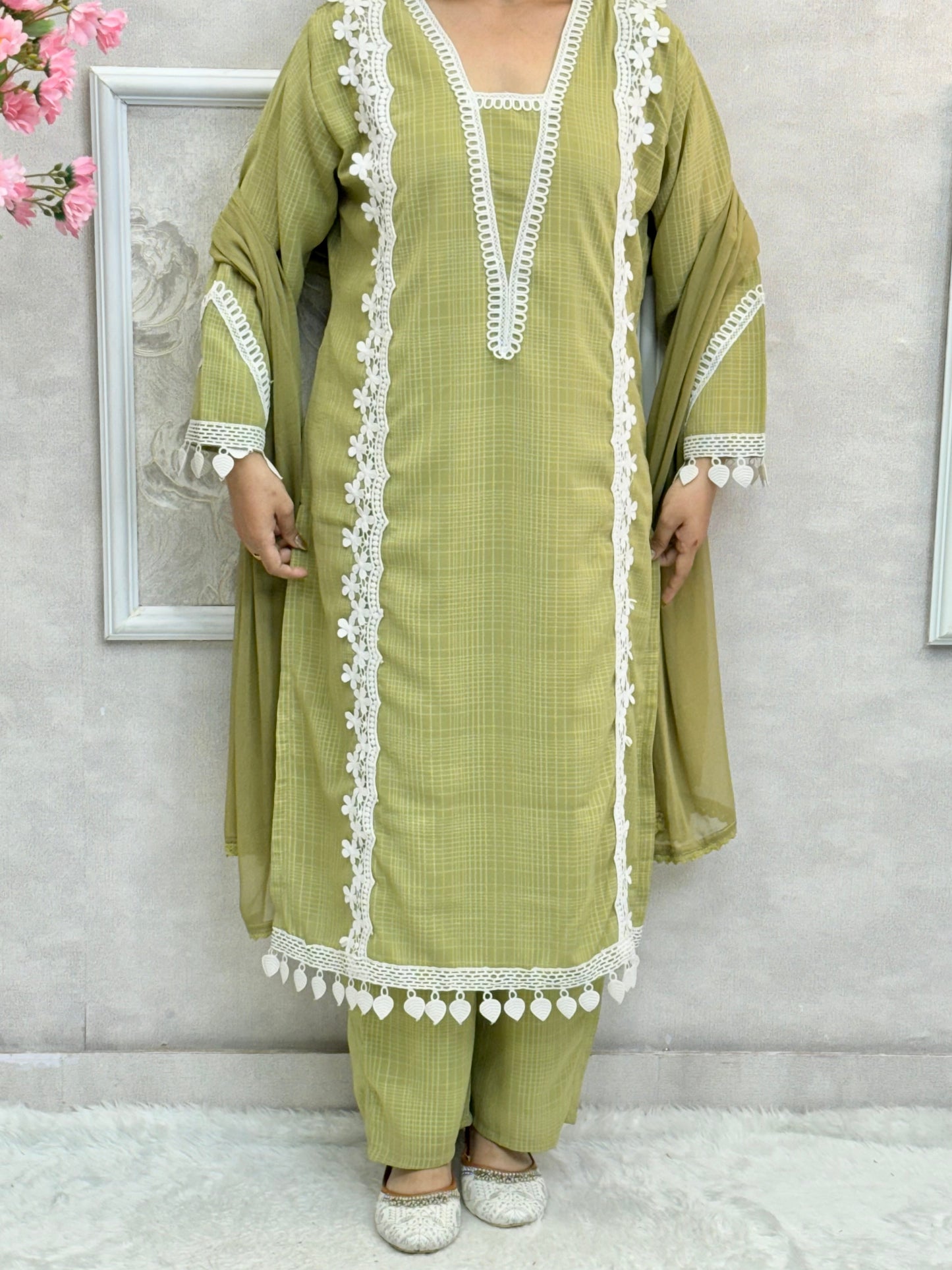 Model wearing an olive green georgette kurta with lacework, paired with georgette pants and a chiffon dupatta – Designer Wear Collection.