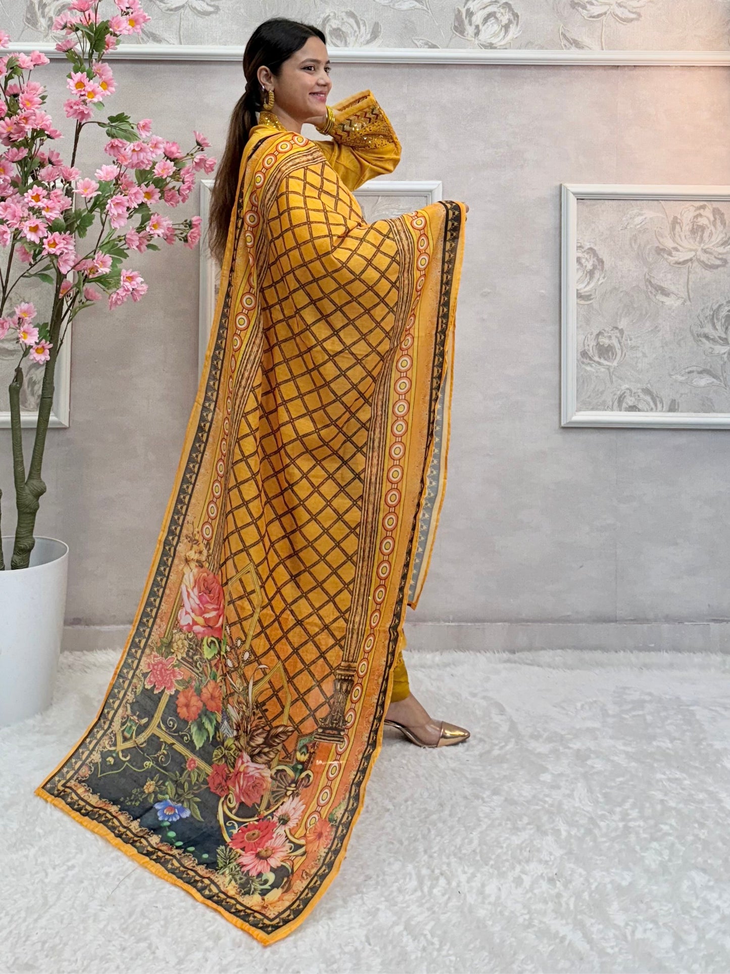 Model wearing a mustard yellow organza kurta with hand embroidery, paired with chanderi pants and a multicolor printed cotton dupatta – Designer Wear Collection.