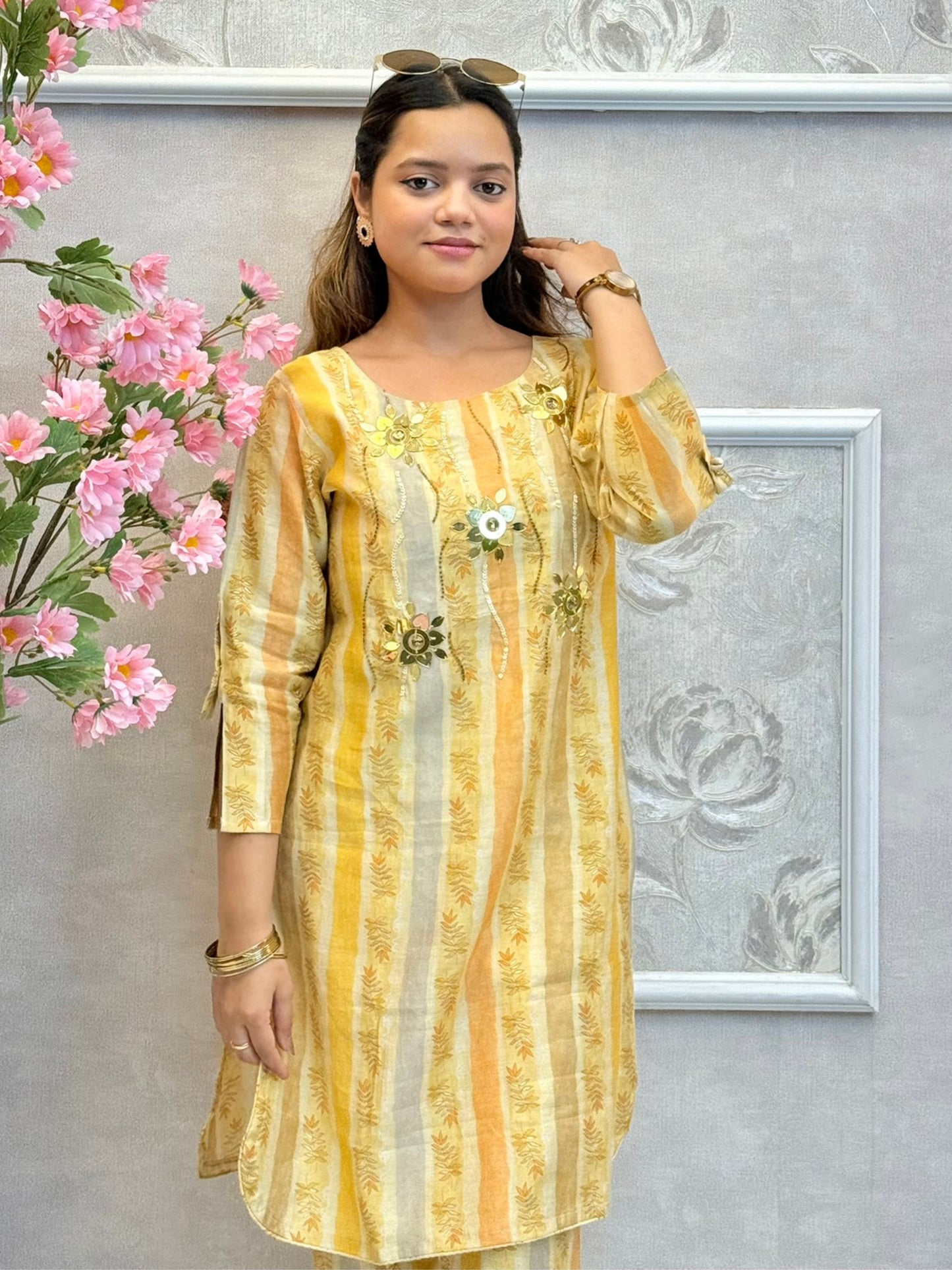 Yellow muslin printed co-ord set with floral embellishments and striped kurta and pants
